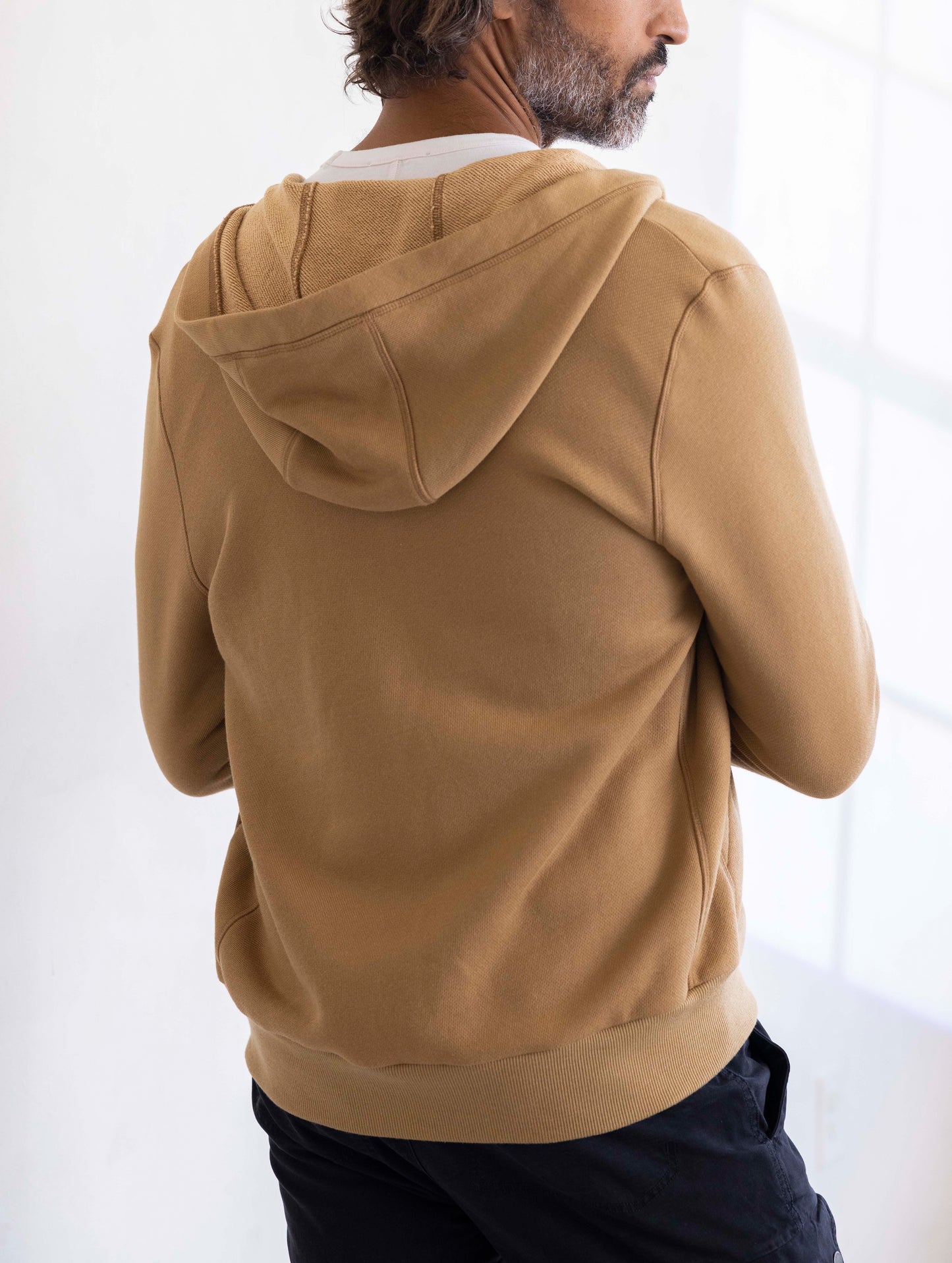 man wearing a brown full zip hoodie