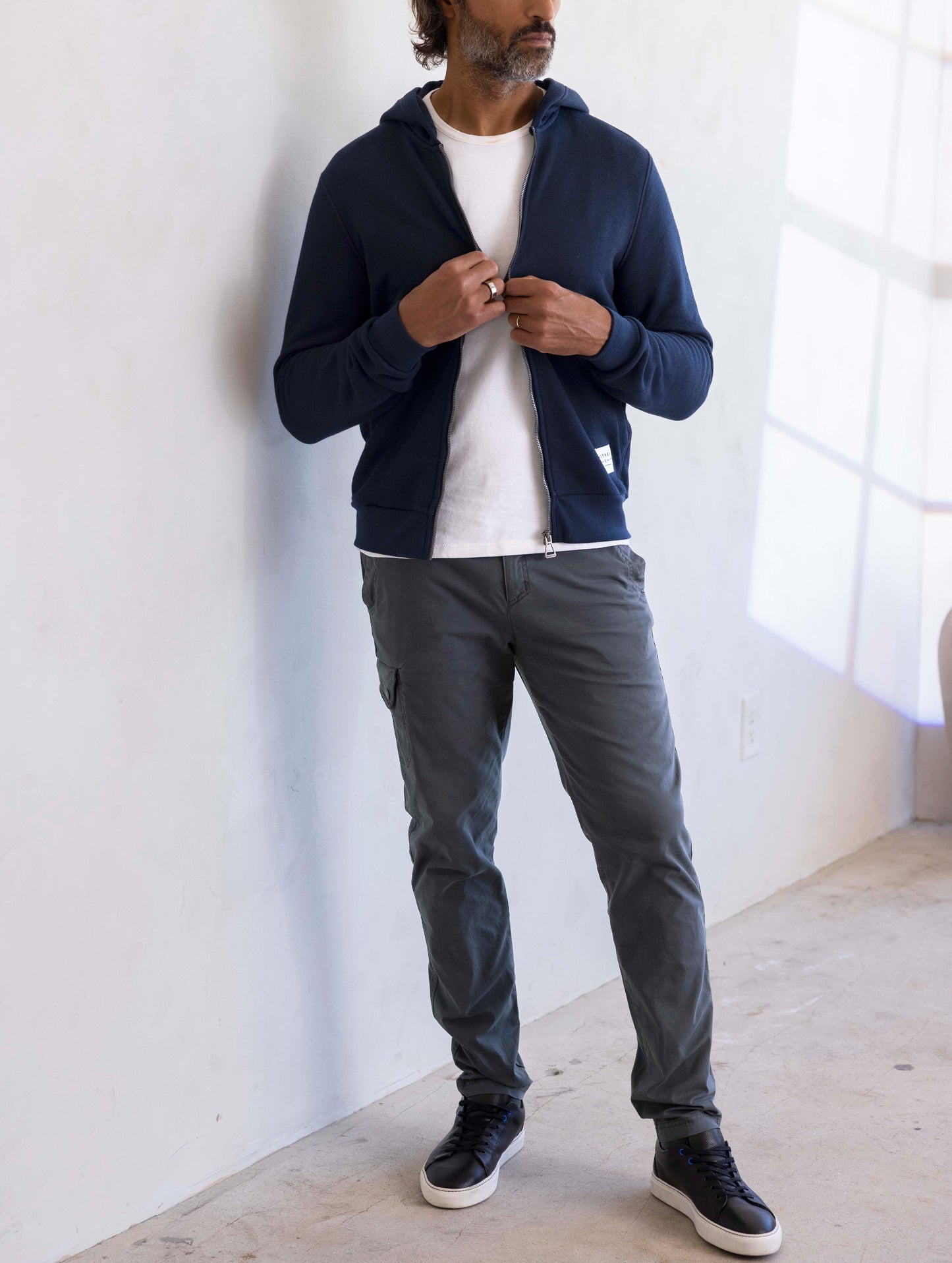 man wearing a navy full zip hoodie