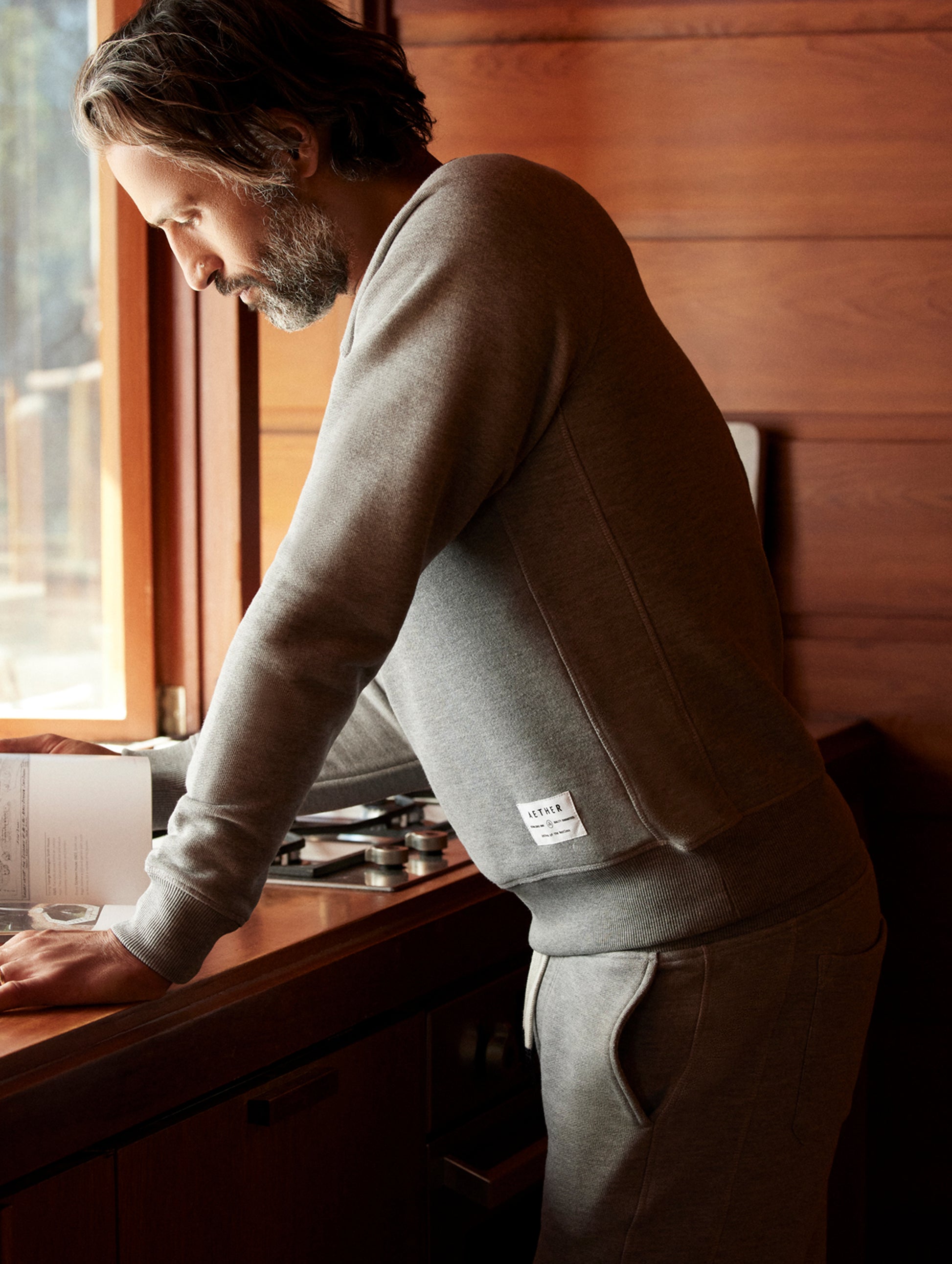 man wearing a grey crew neck with pocket
