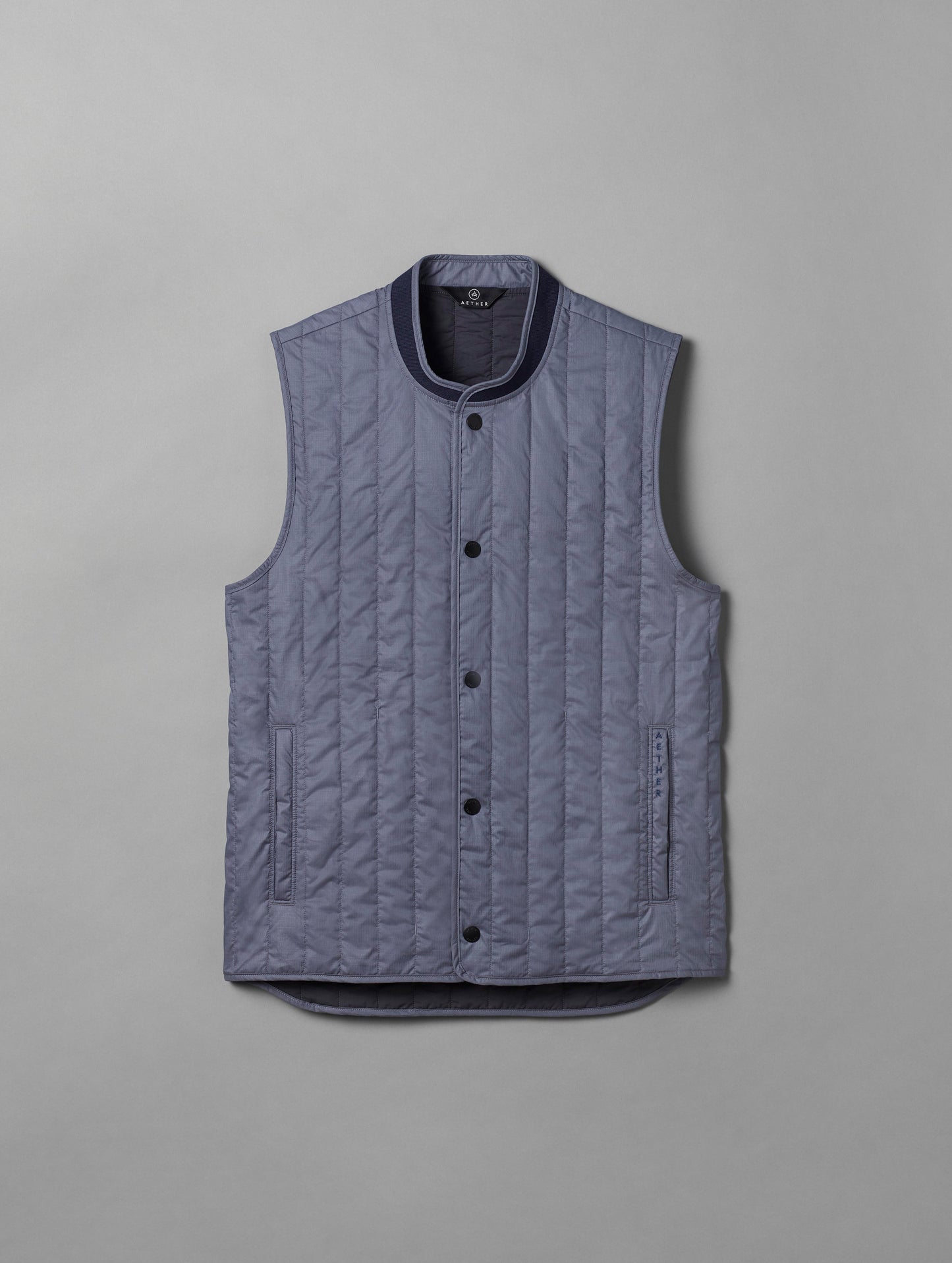Flat lay of light blue Griffith Vest from AETHER Apparel.