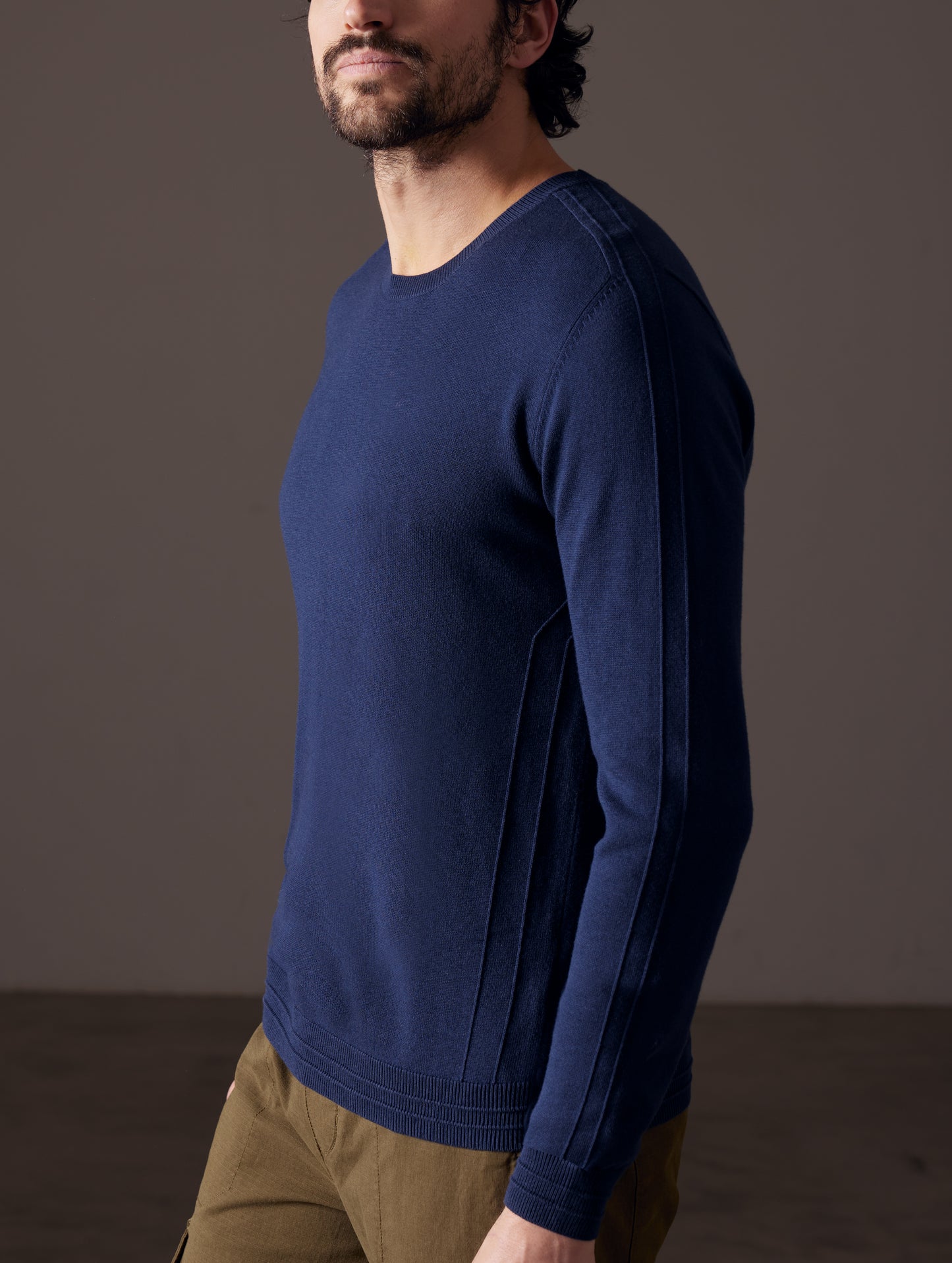 Front 3/4 body view of man wearing Irving Sweater in Total Eclipse dark blue from AETHER Apparel.