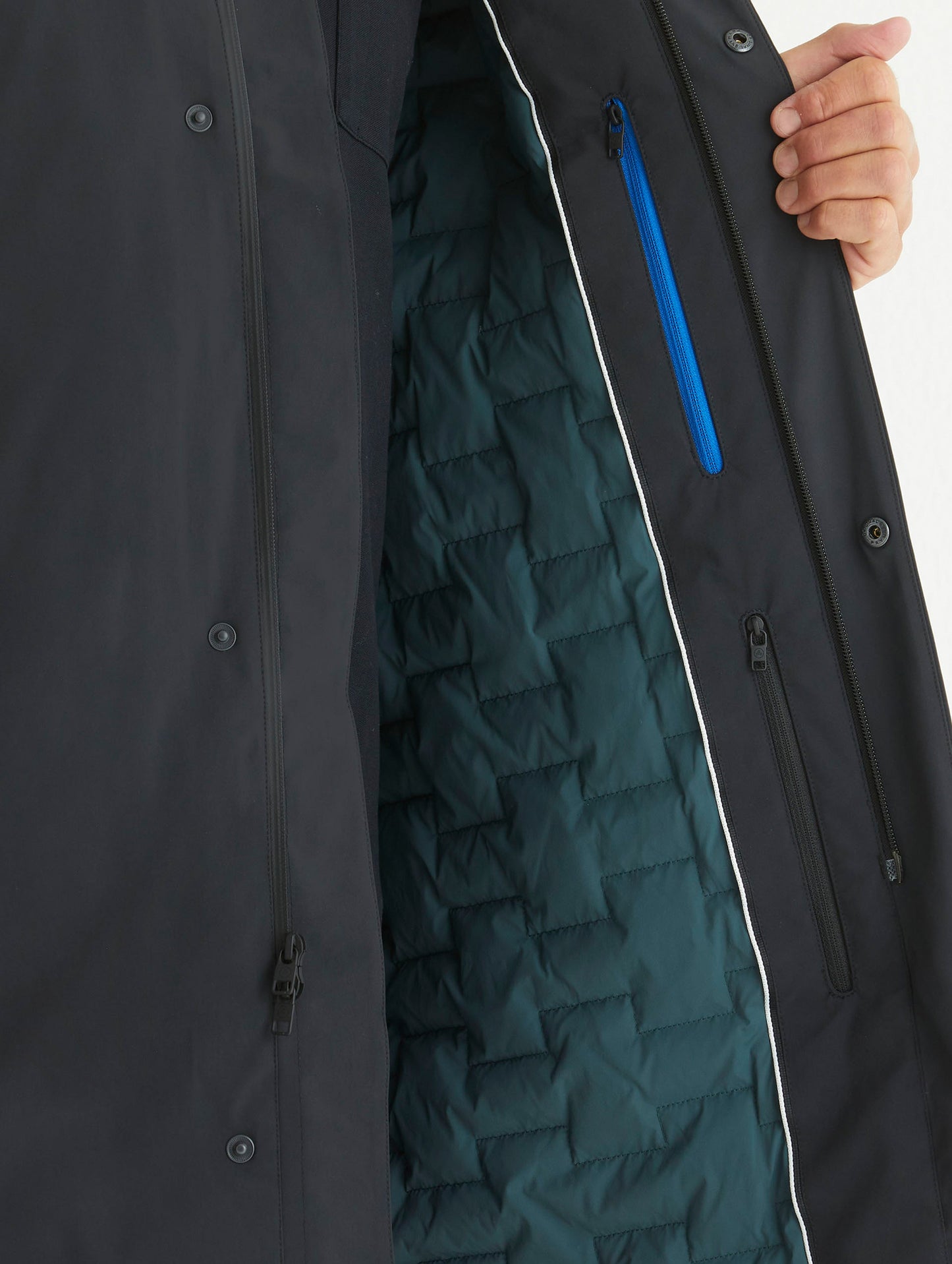 Detailed view at quilted lining and zippered pockets of Isaac Jacket in Onyx Black from AETHER Apparel.