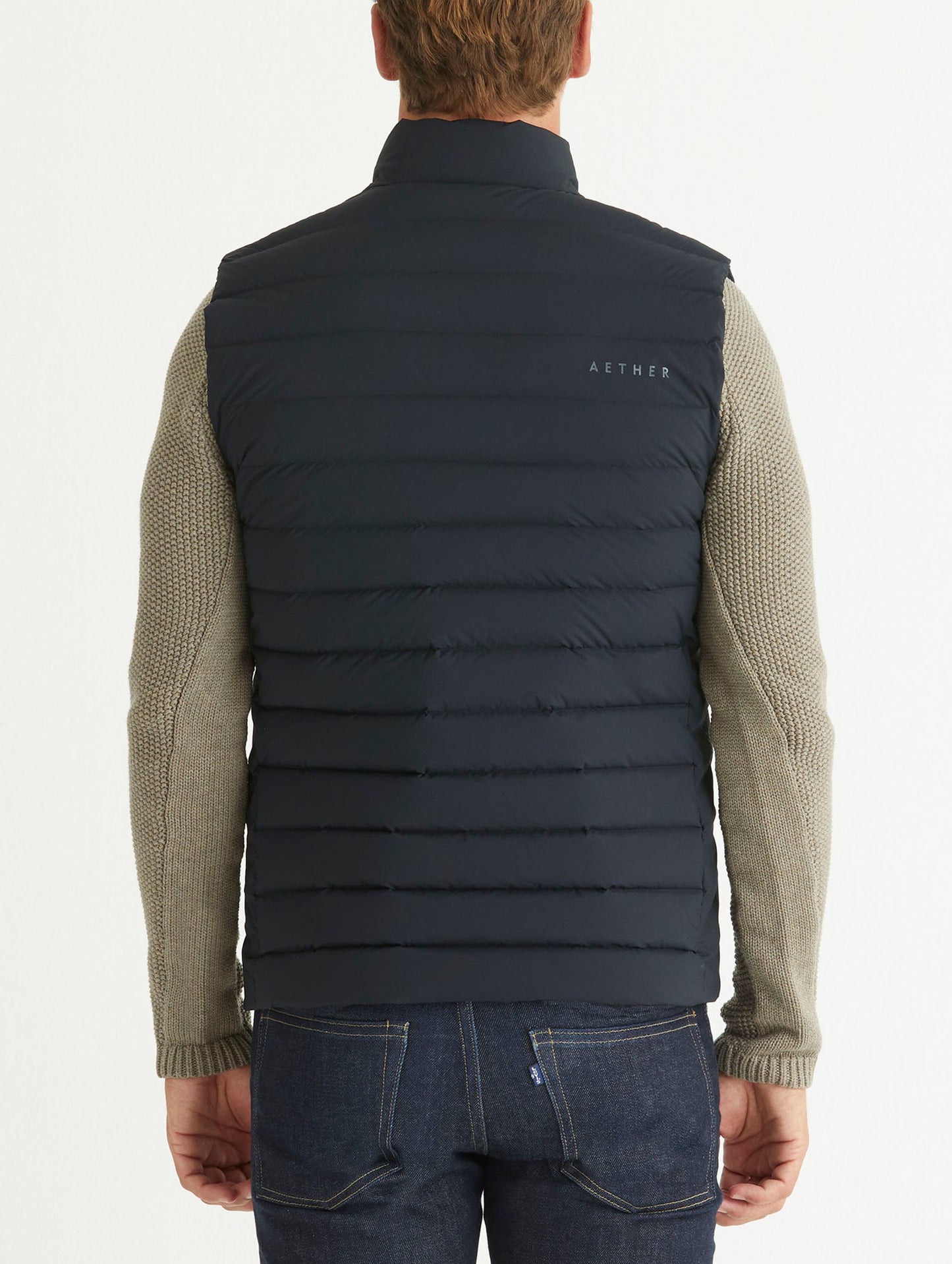 Rear body view of man wearing Launch Vest in Onyx Black from AETHER Apparel.
