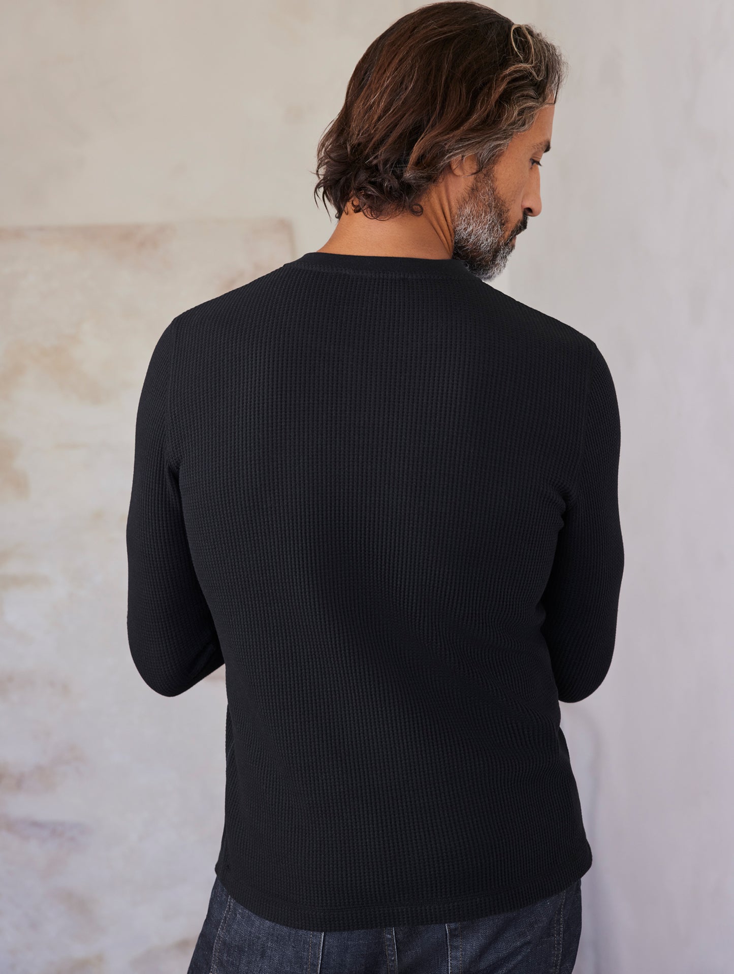 man wearing black long sleeve henley