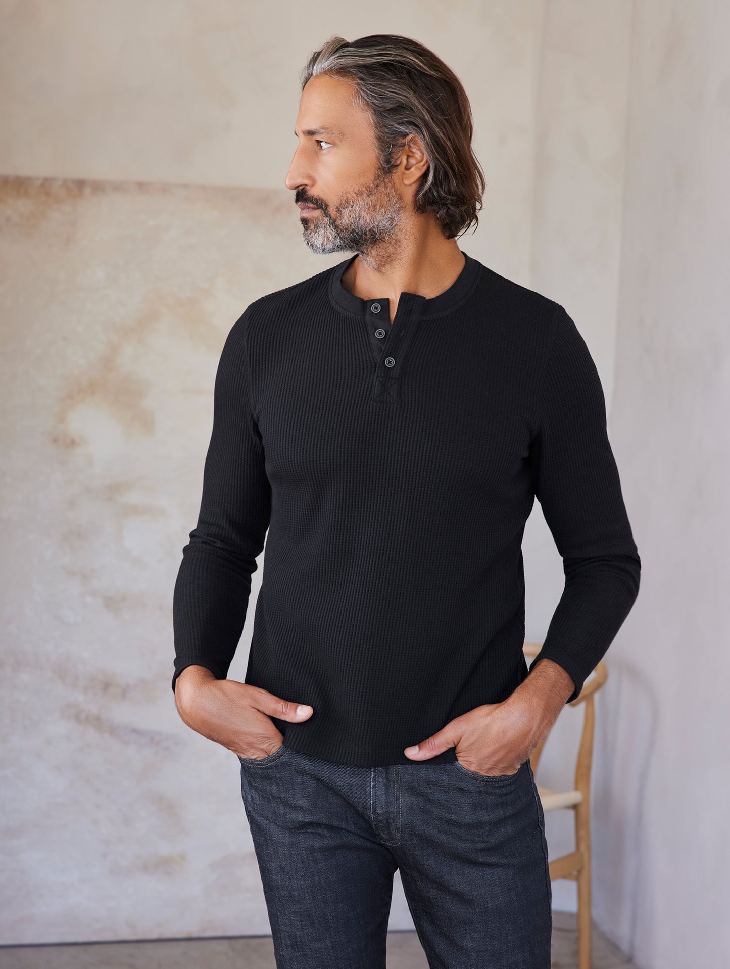 man wearing black long sleeve henley