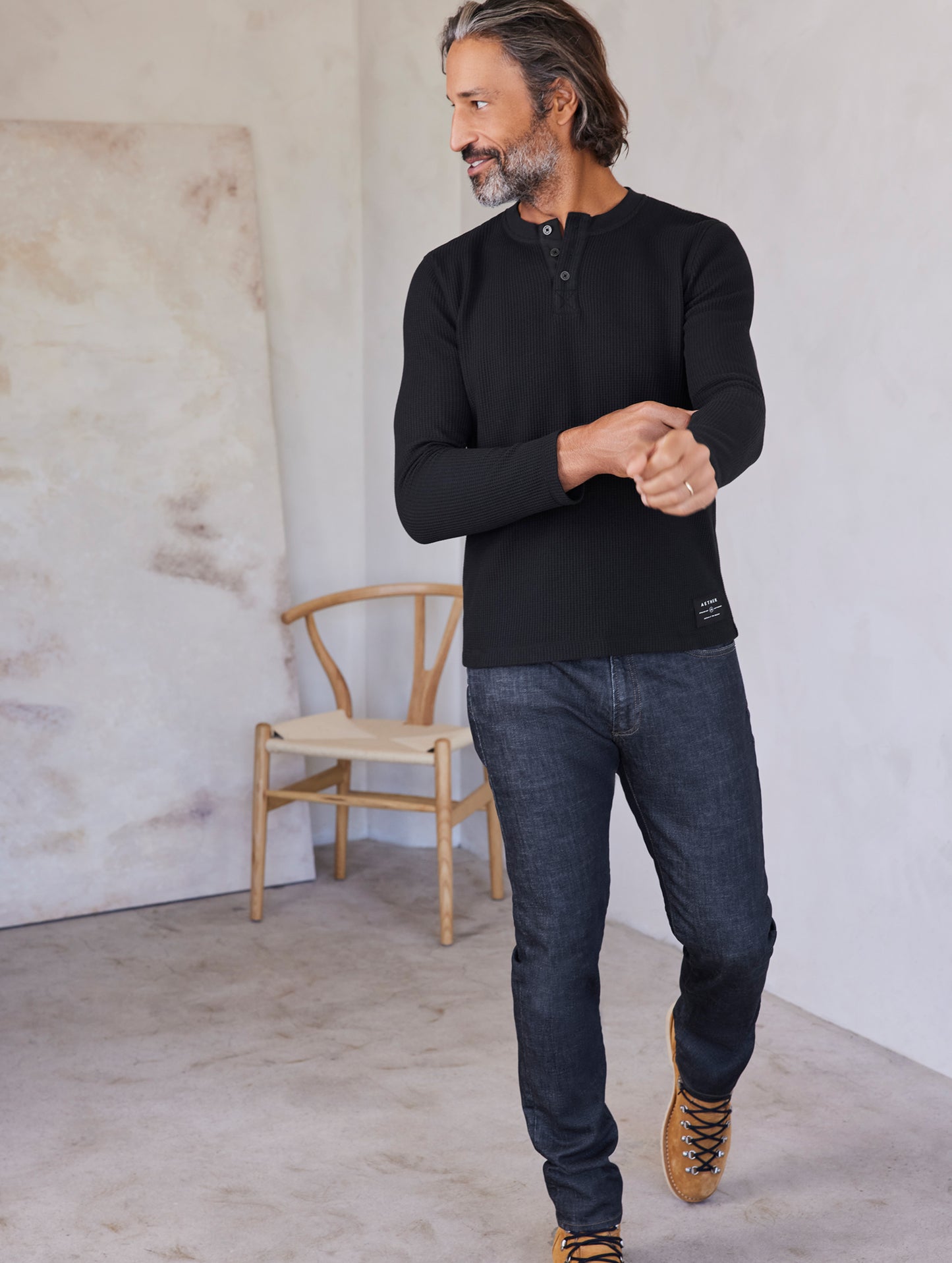 man wearing black long sleeve henley