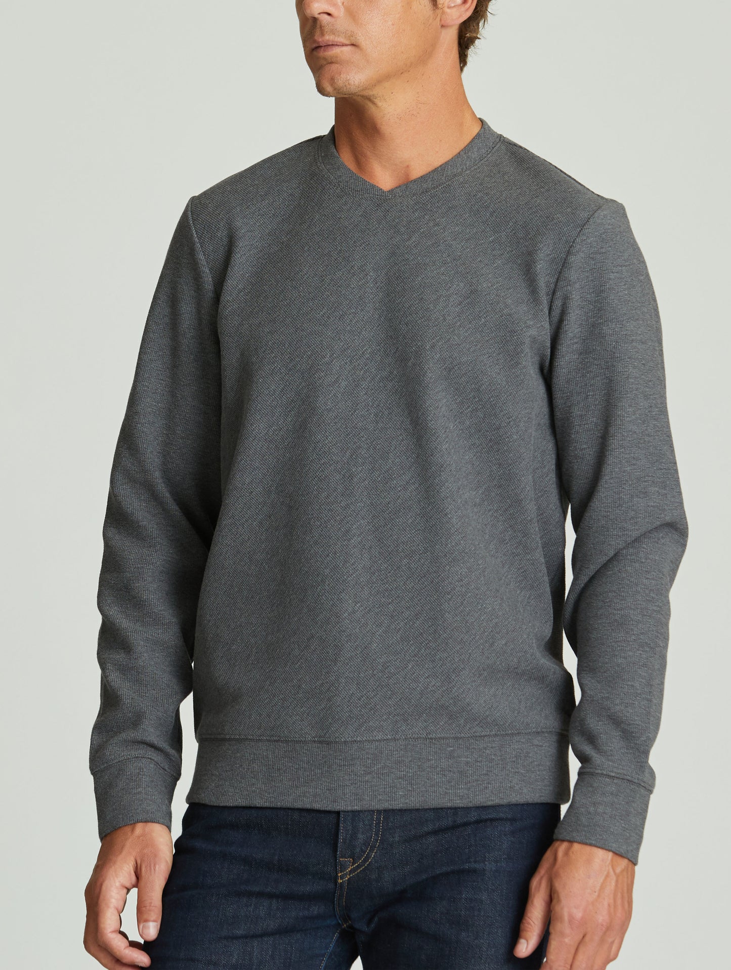 man wearing grey pullover