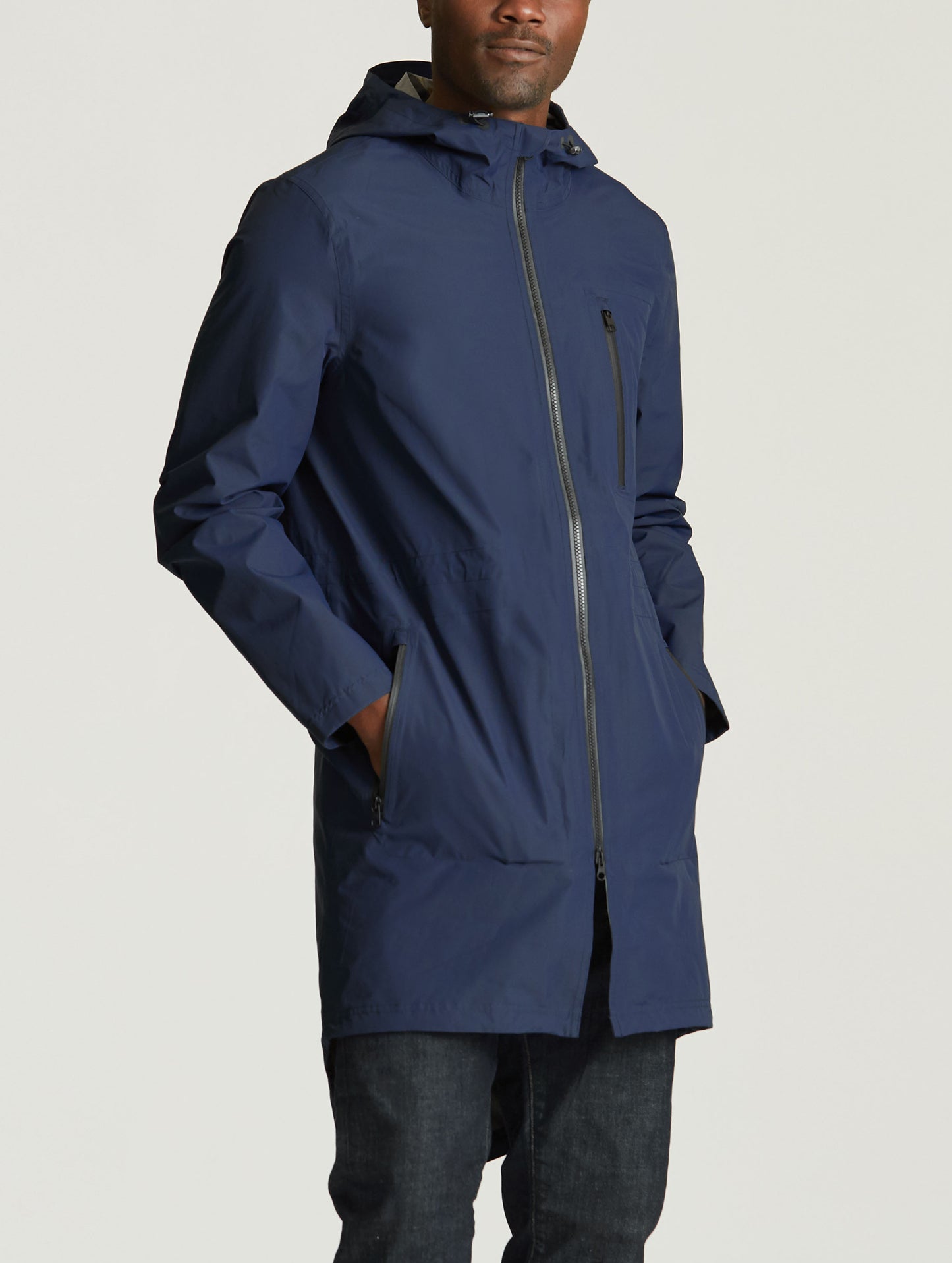 Angled front view of man wearing blue Meridian Jacket from AETHER Apparel.
