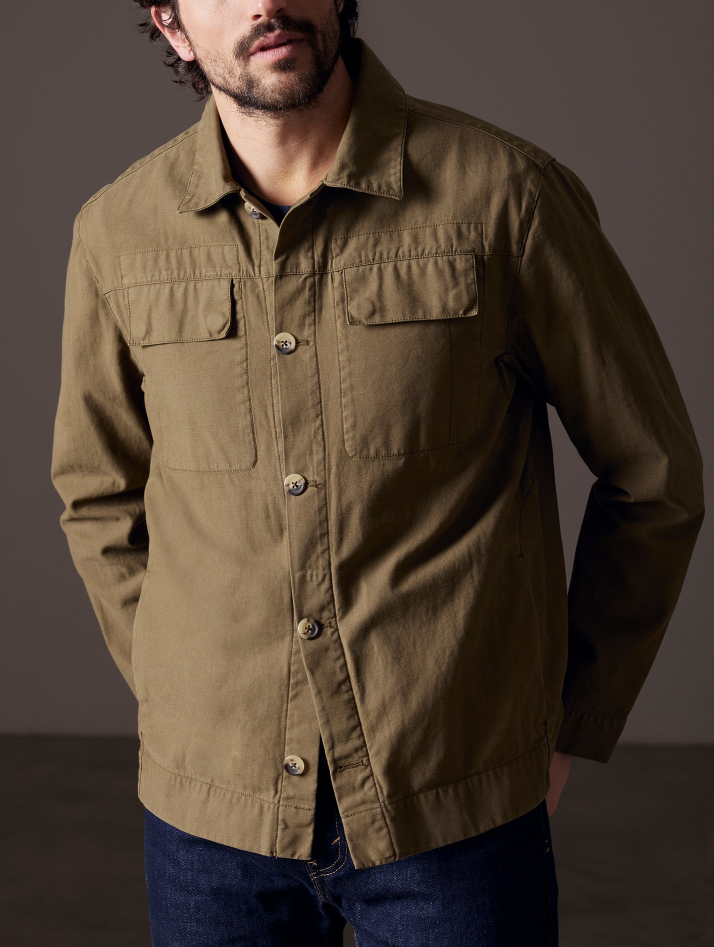 Front body view of man wearing Mesa Jacket in Command Green from AETHER Apparel.