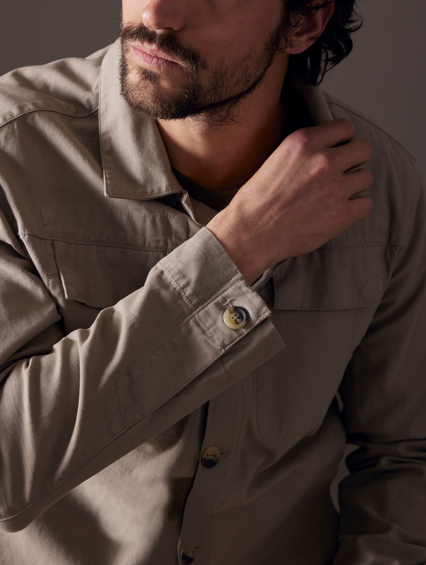 Closeup detailed view of man wearing Mesa Jacket in Laurel Grey from AETHER Apparel.