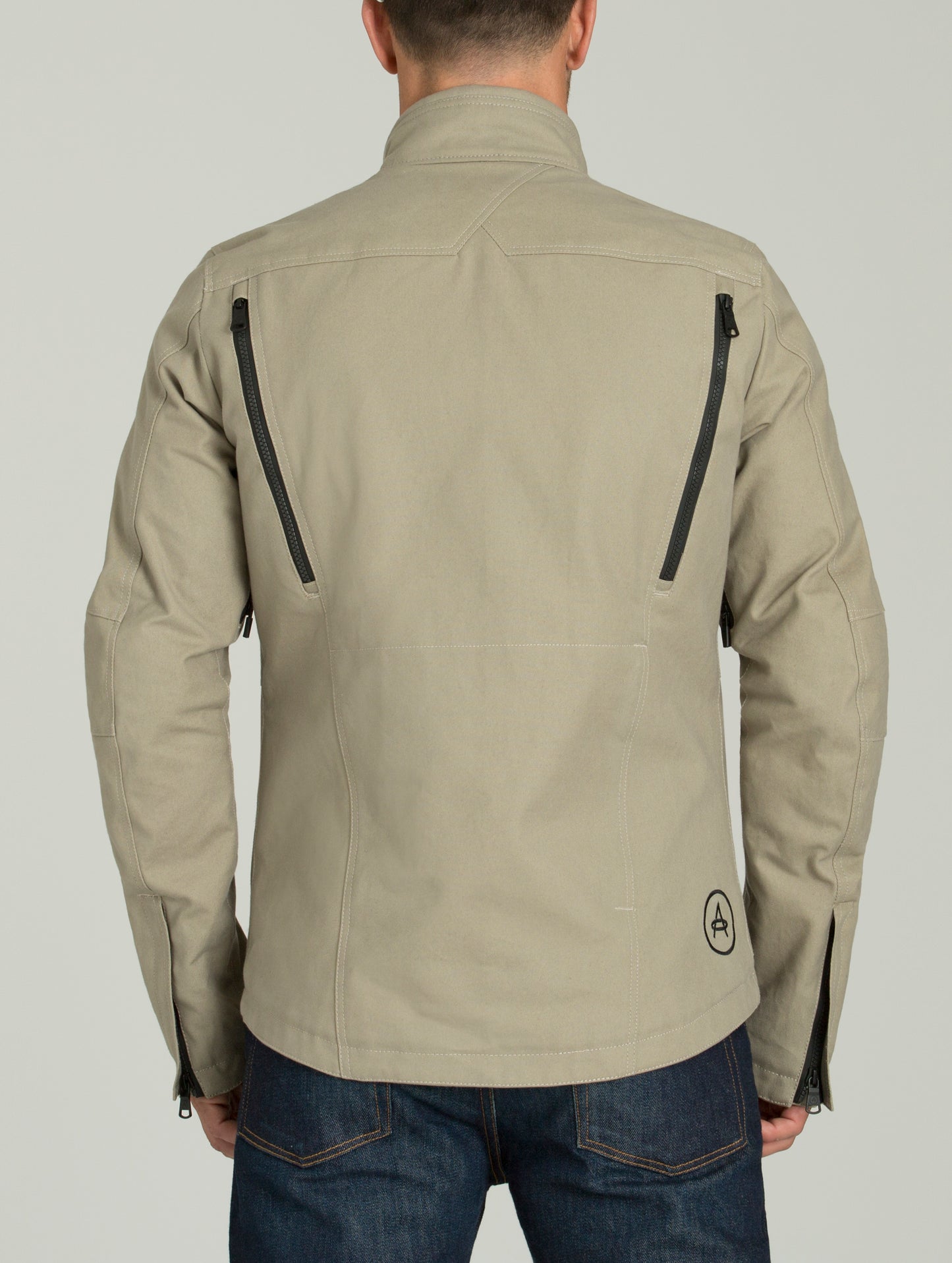 Rear body view of man wearing Mojave Motorcycle Jacket in Dark Sand from AETHER Apparel.