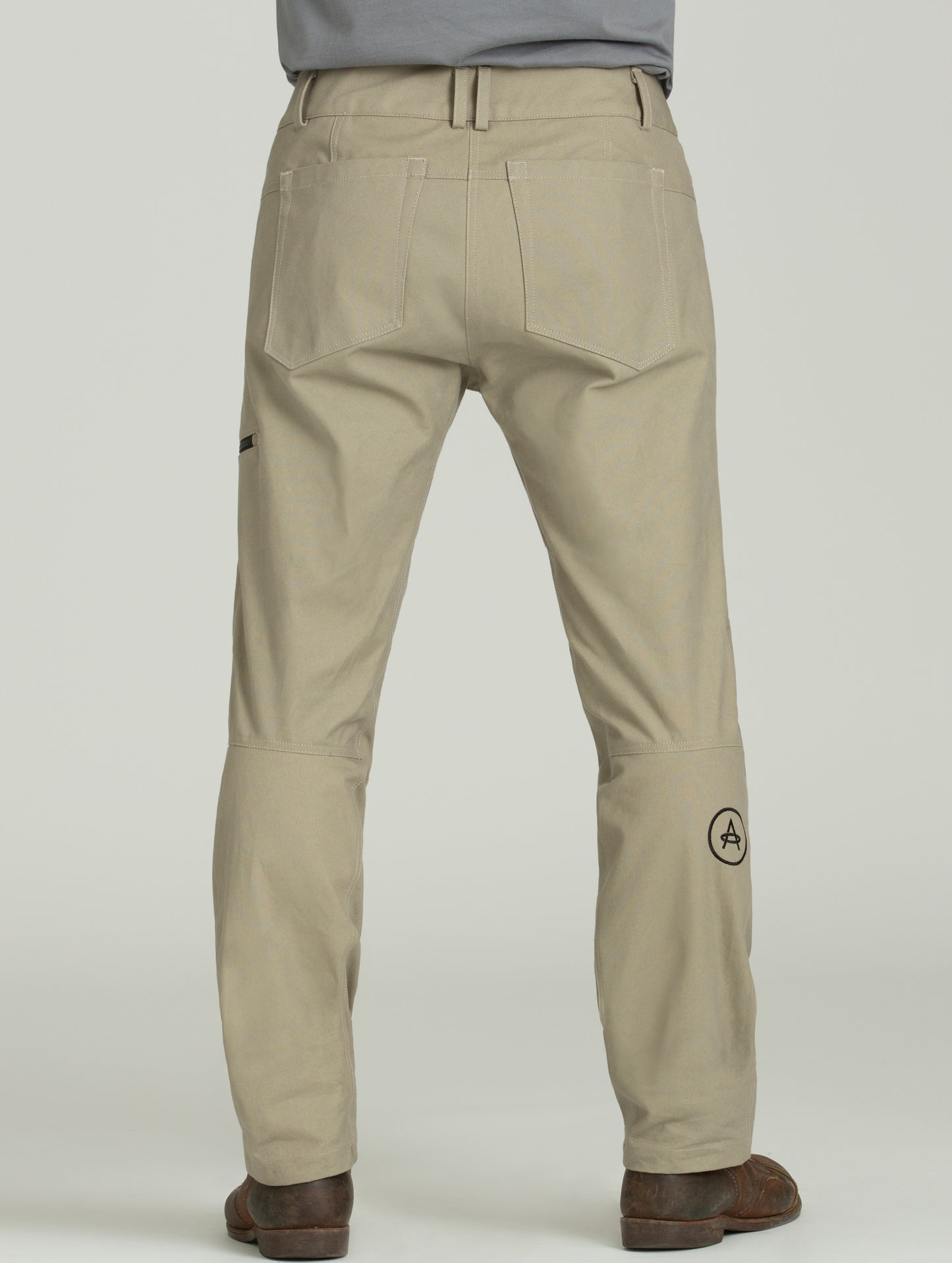 man wearing tan motorcycle pants