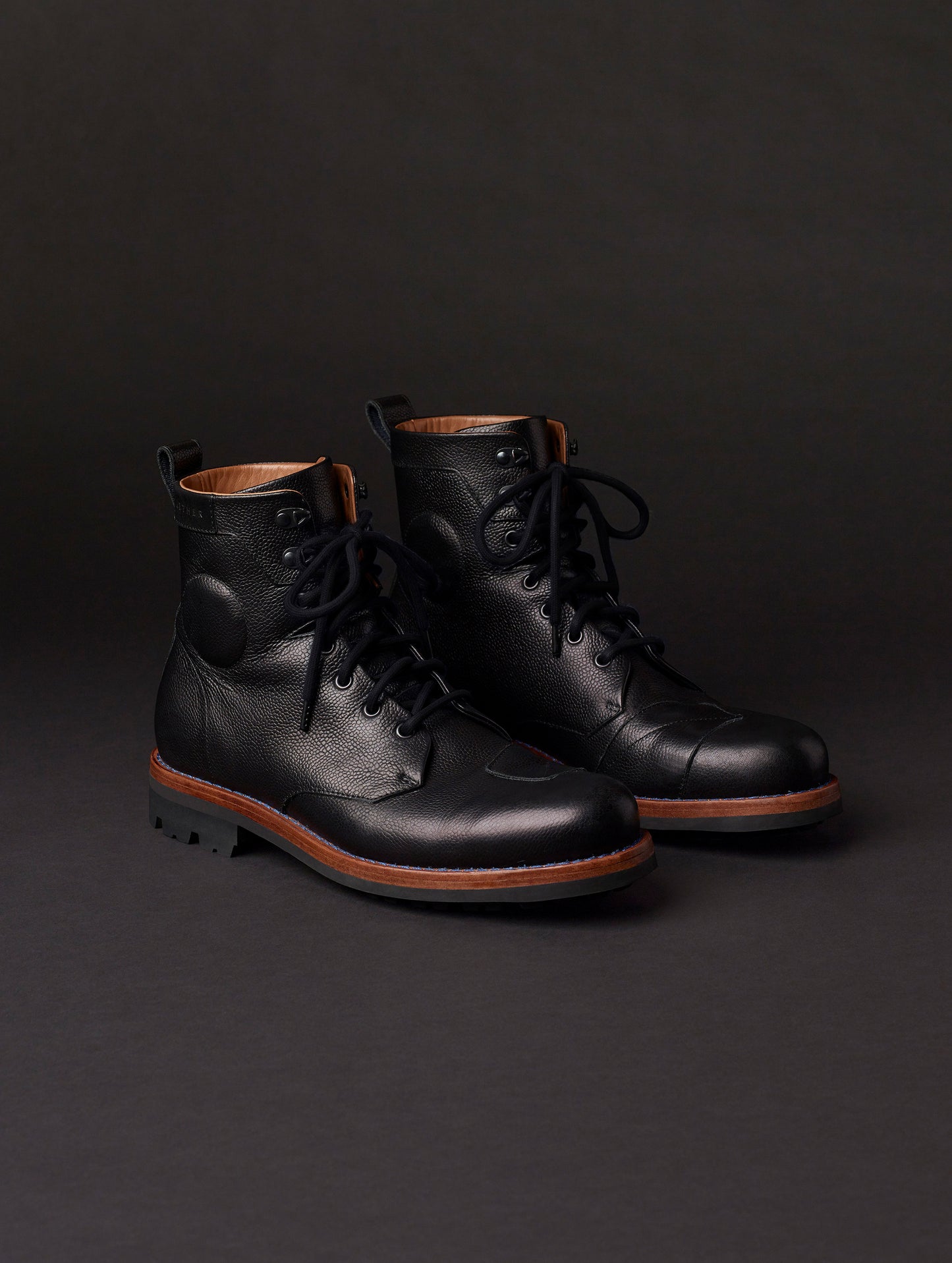 Front angled view of AETHER Moto Boot in Jet Black with black laces from AETHER Apparel.