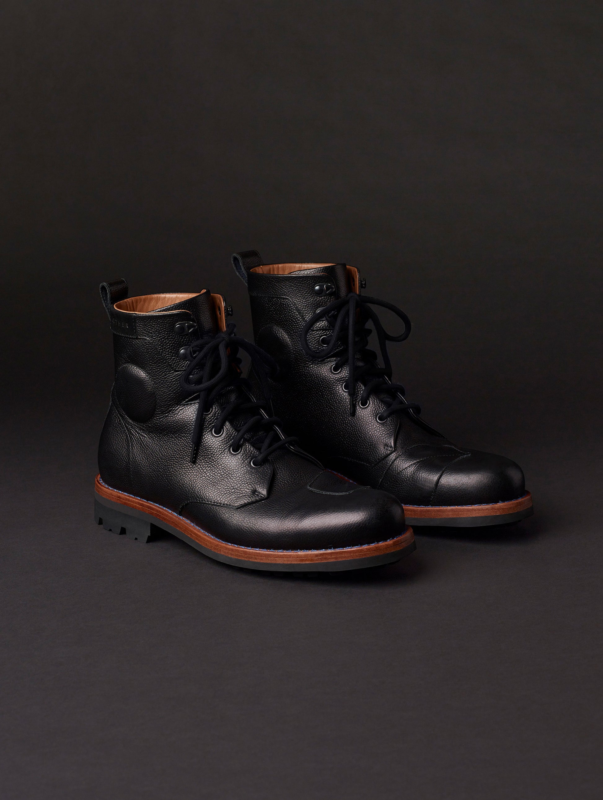 Front angled view of AETHER Moto Boot in Jet Black with black laces from AETHER Apparel.