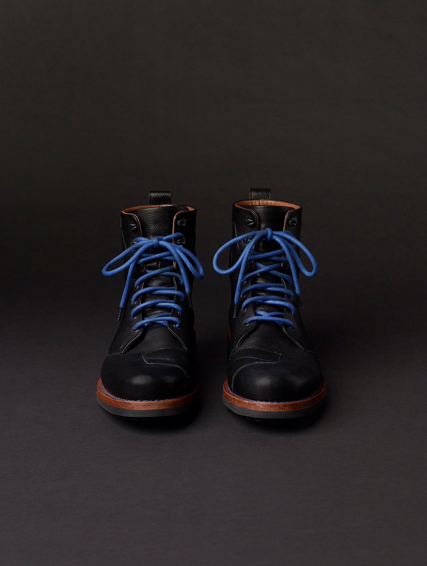 Front view of AETHER Moto Boot in Jet Black with blue laces from AETHER Apparel.