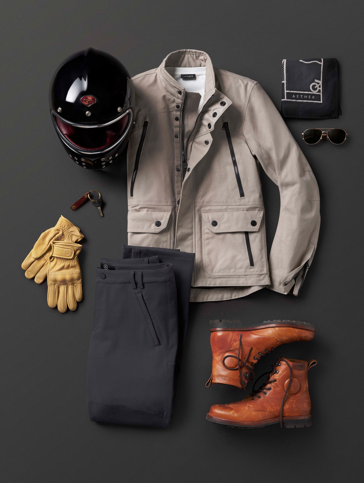 Flay lay of AETHER Moto Boot alongside motorcycle outfit.