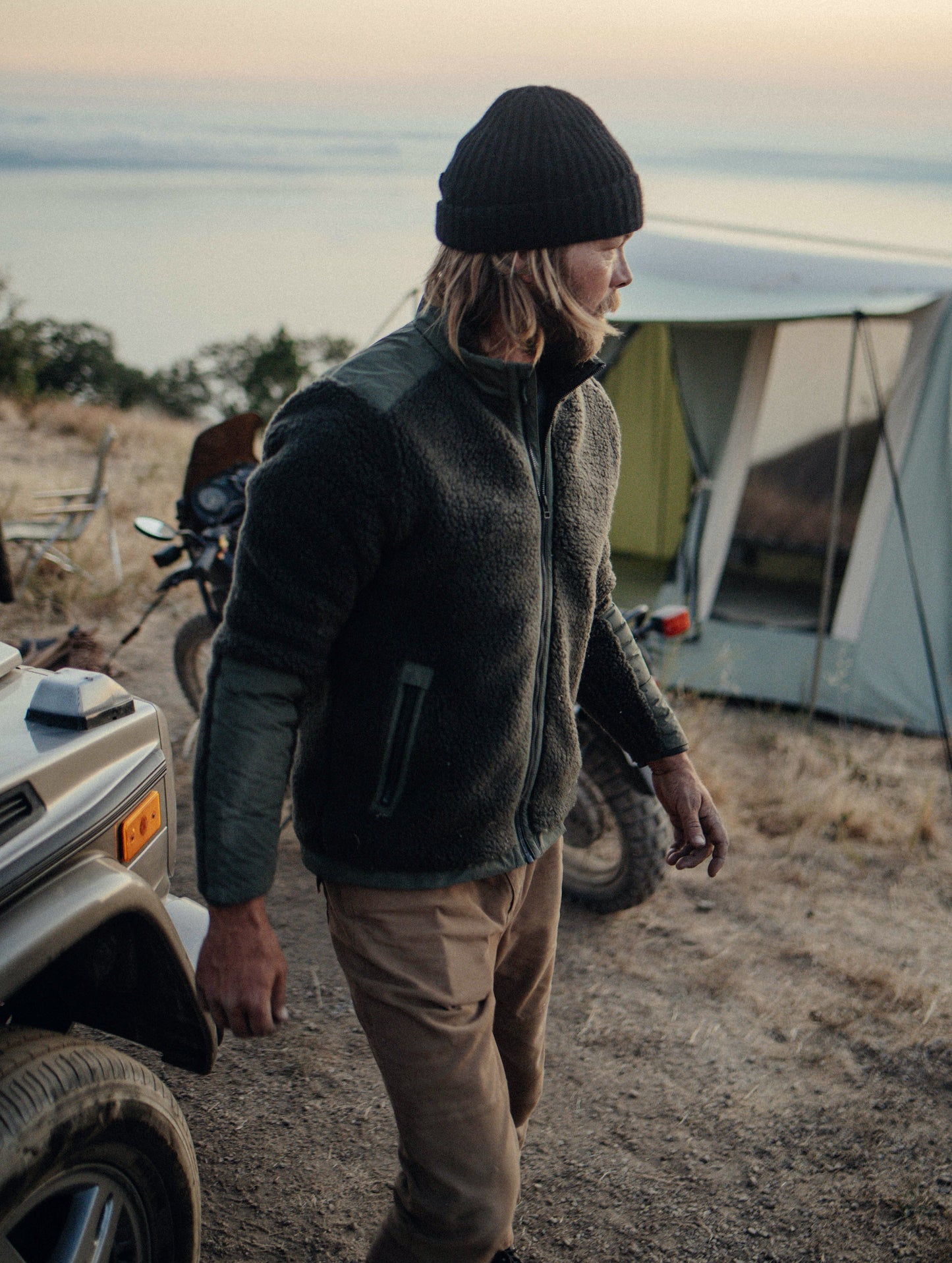 Front 3/4 outdoor lifestyle image of Narrows Jacket in Duffle Green from AETHER Apparel.