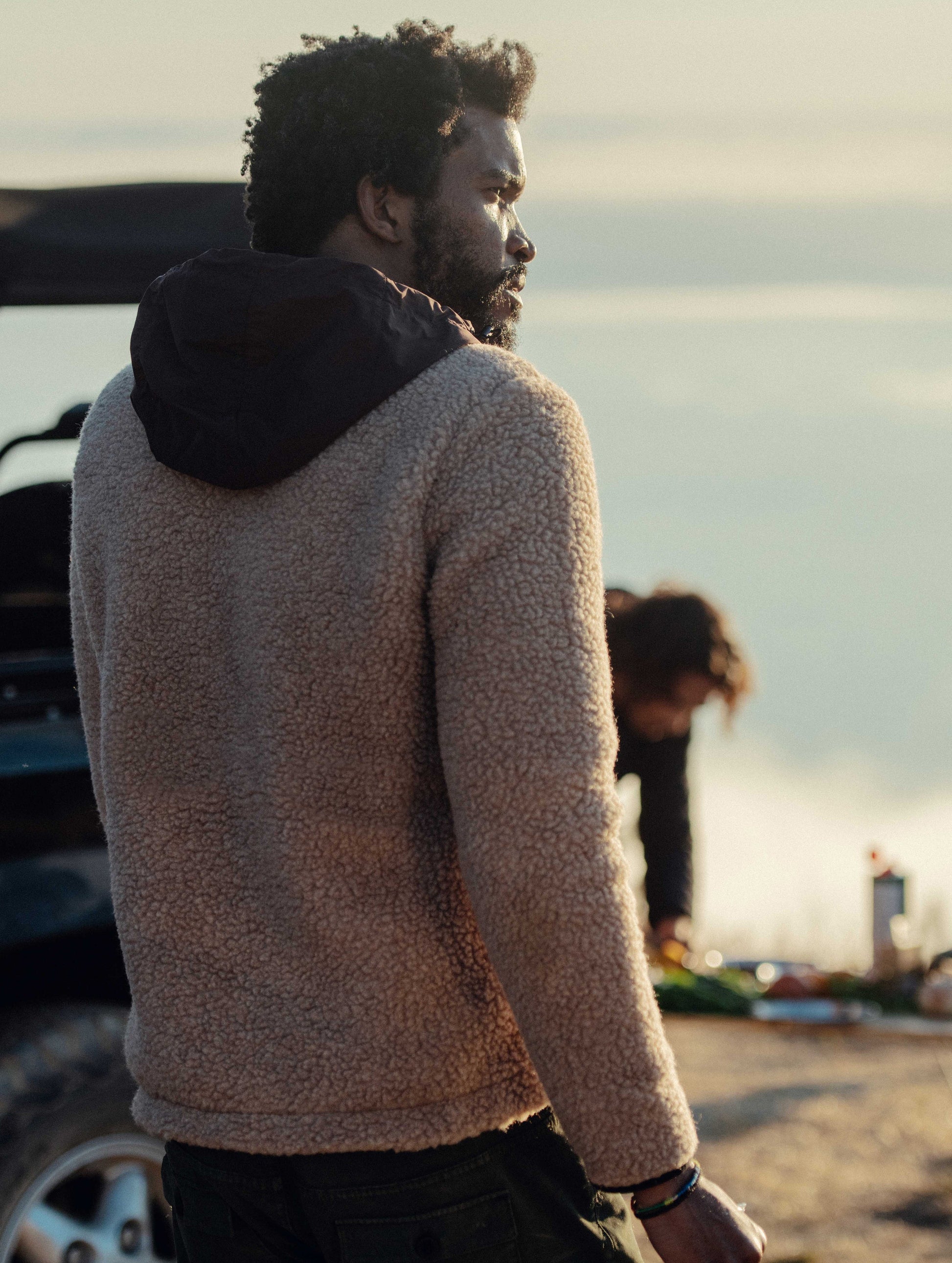 Rear 3/4 outdoor lifestyle image of Narrows Pullover in Camel from AETHER Apparel.