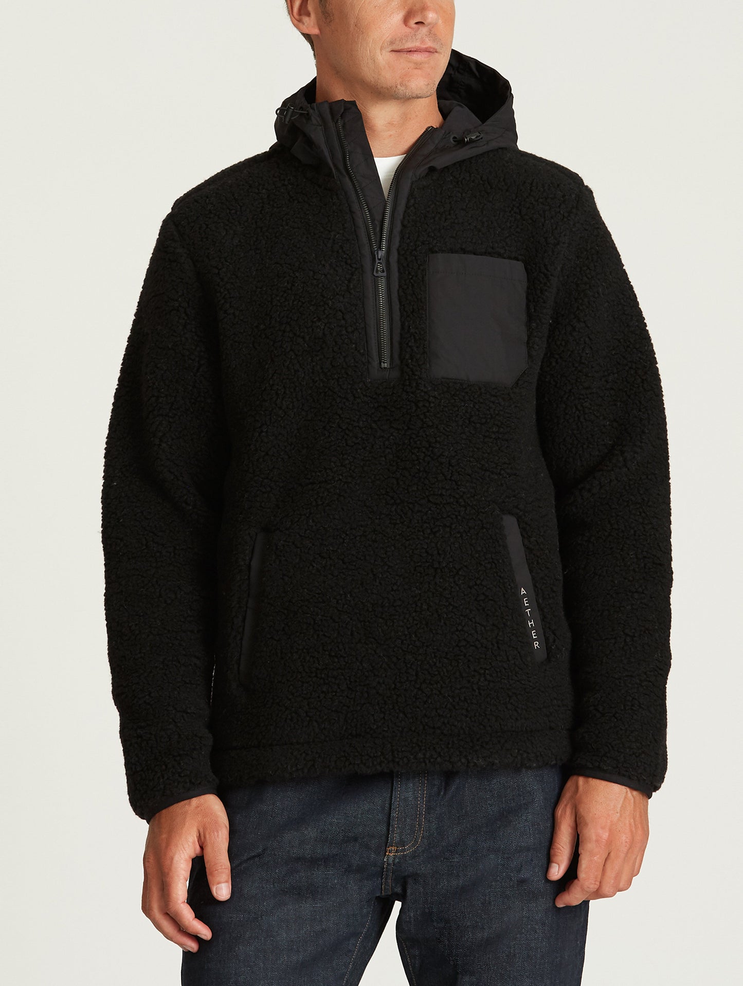 Front body view of man wearing Narrows Pullover in Onyx Black from AETHER Apparel.