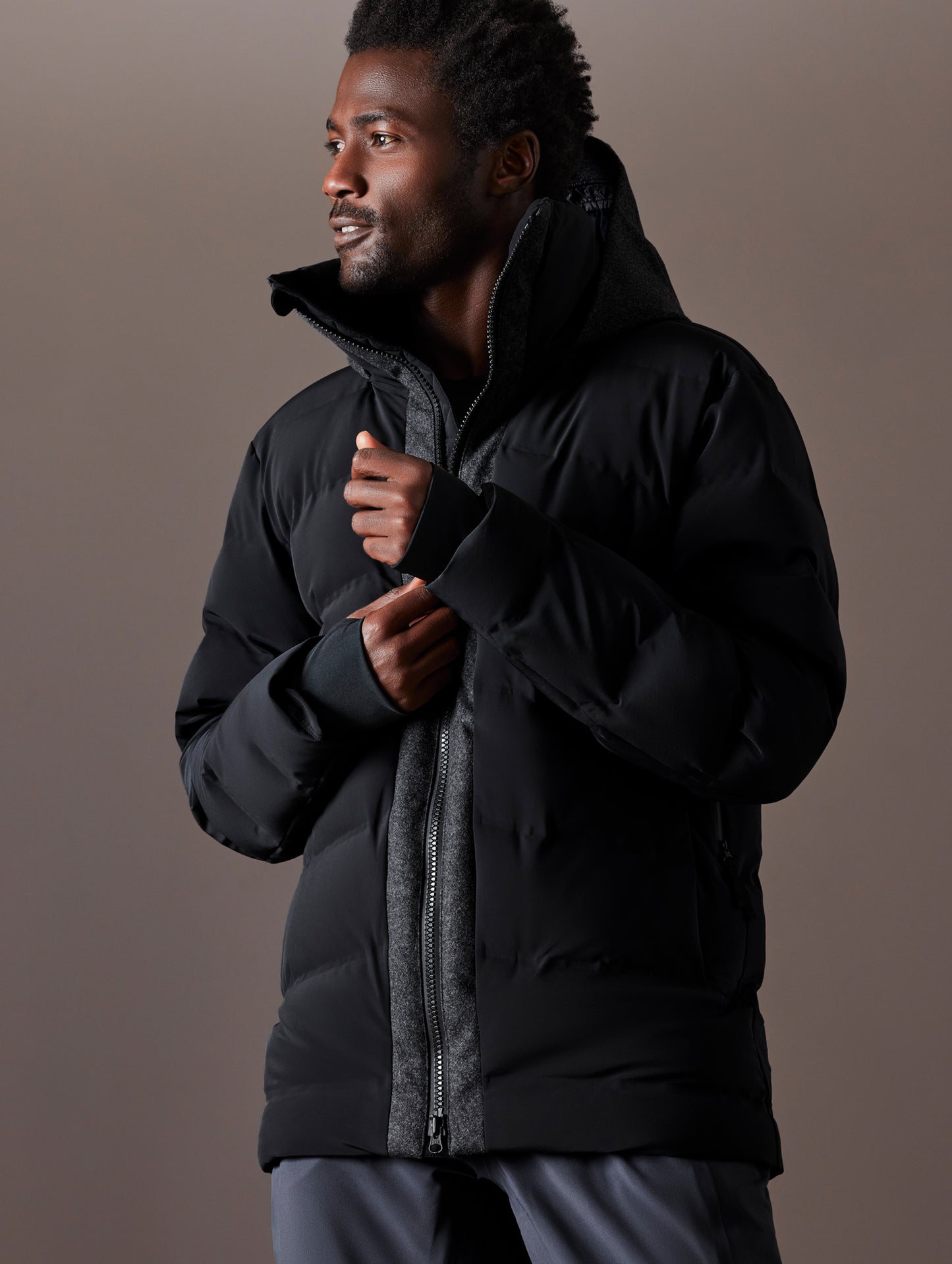 Front 3/4 body view of man wearing Nordic Jacket in Jet Black from AETHER Apparel.