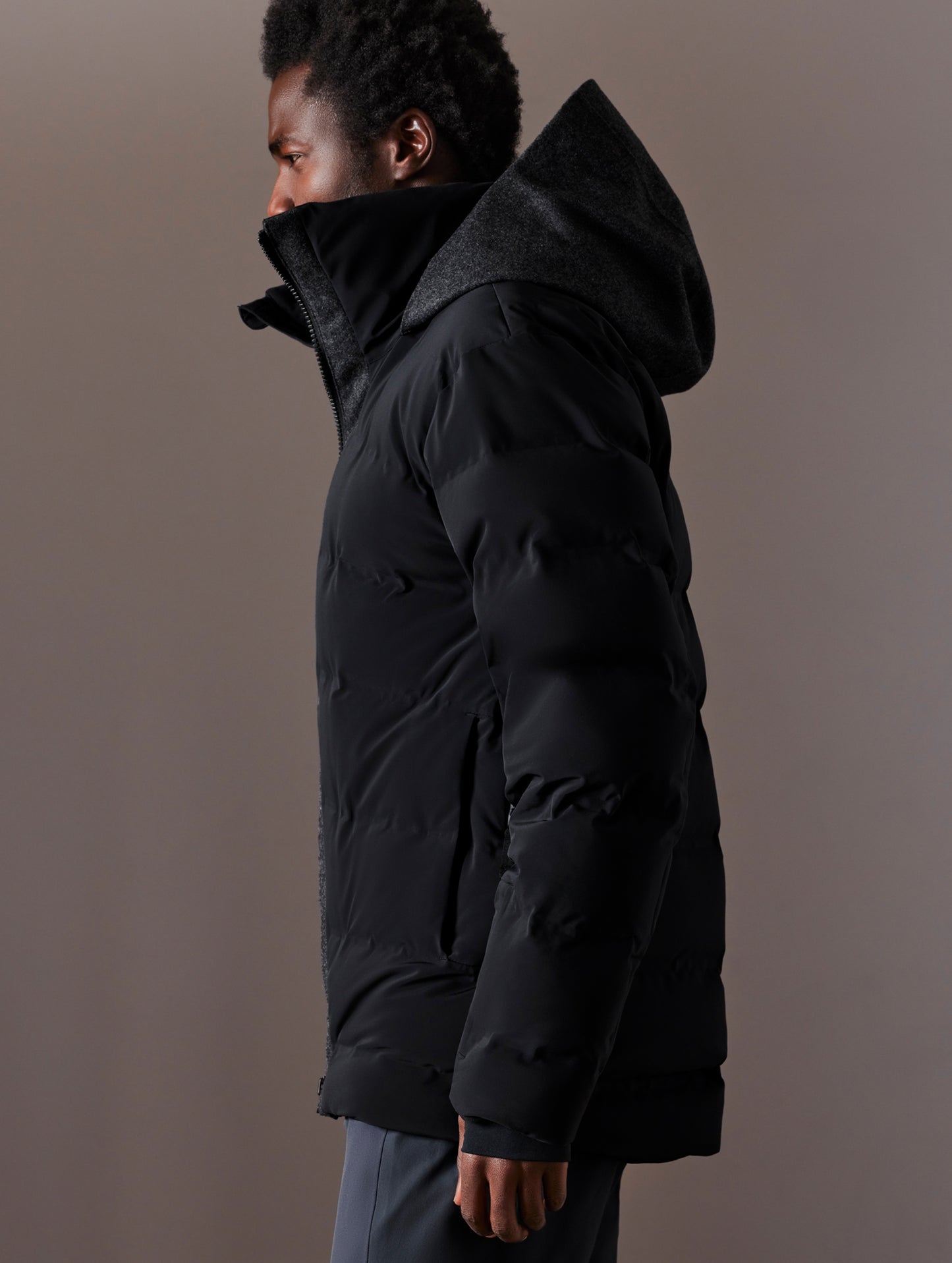 Left side profile body view of man wearing Nordic Jacket in Jet Black from AETHER Apparel.