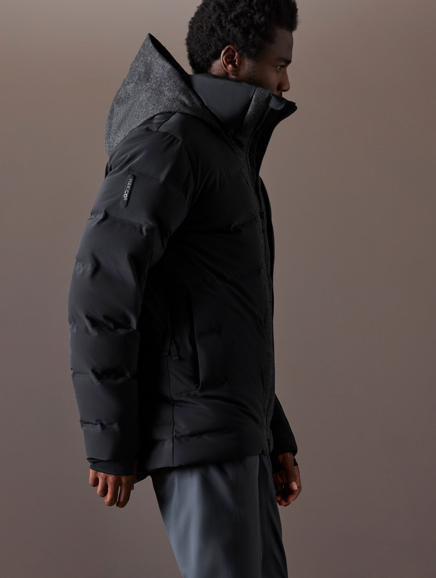 Right side profile body view of man wearing Nordic Jacket in Jet Black from AETHER Apparel.
