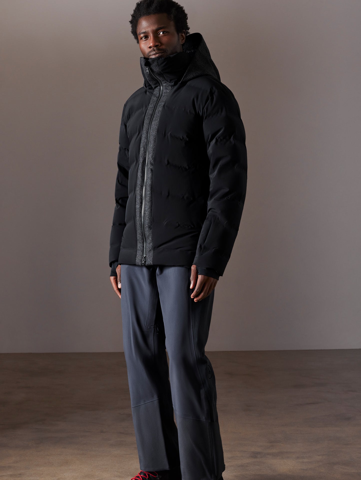 Front 3/4 full-body view of man wearing Nordic Jacket in Jet Black from AETHER Apparel.