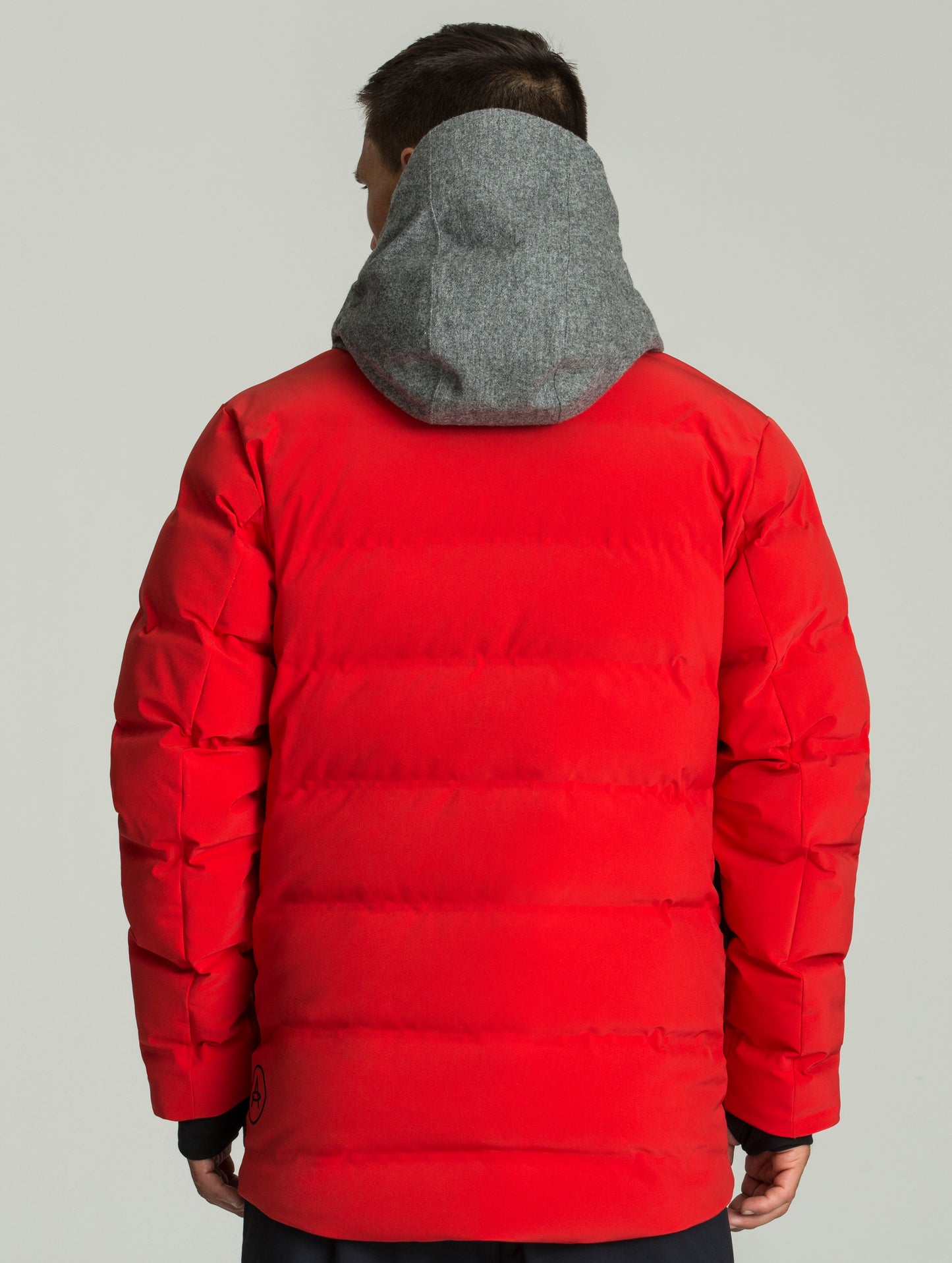 Rear body view of man wearing Nordic Jacket in Racing Red from AETHER Apparel.