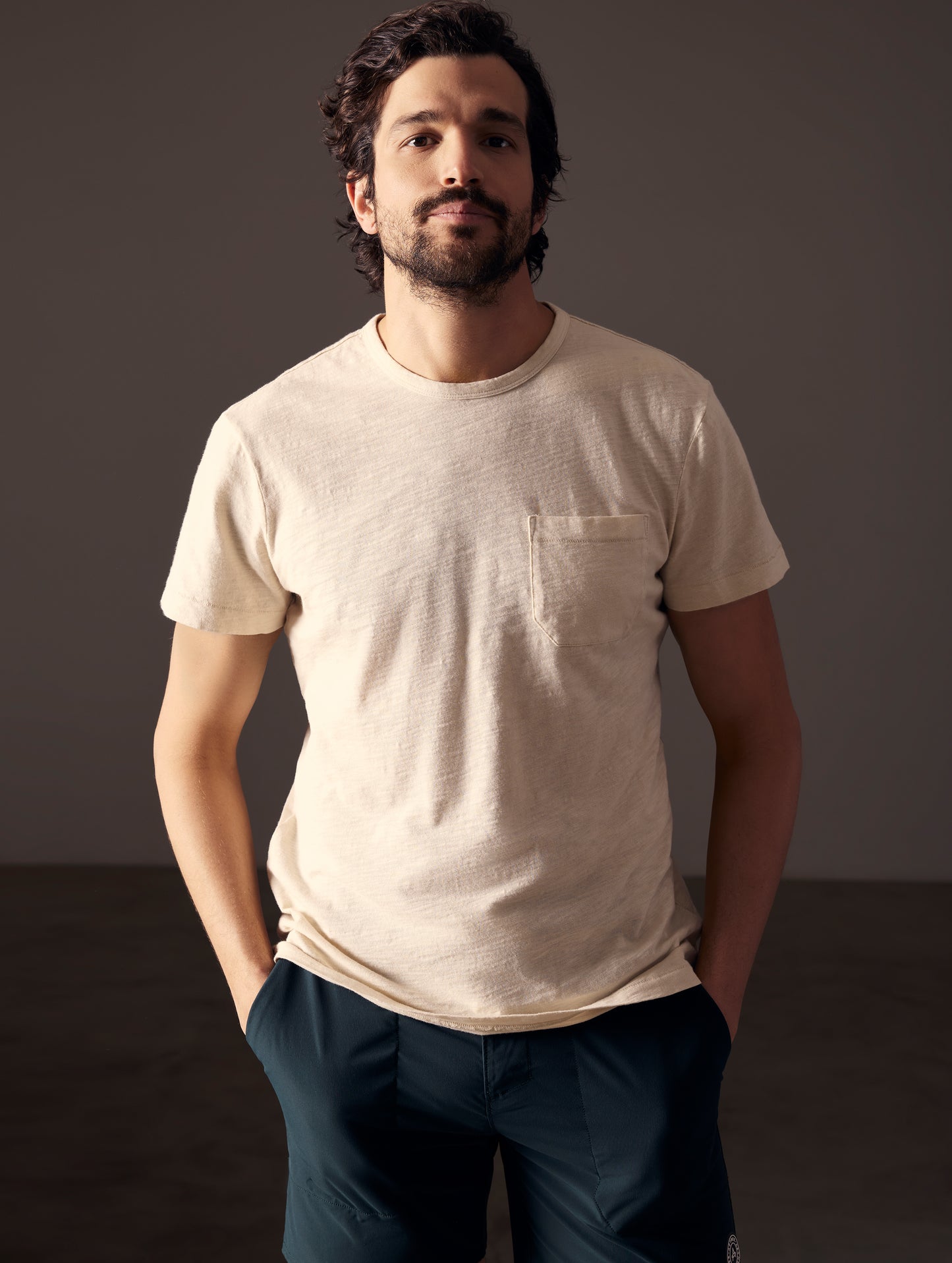 Front body view of man wearing Slub Pocket Tee in Bone white from AETHER Apparel.