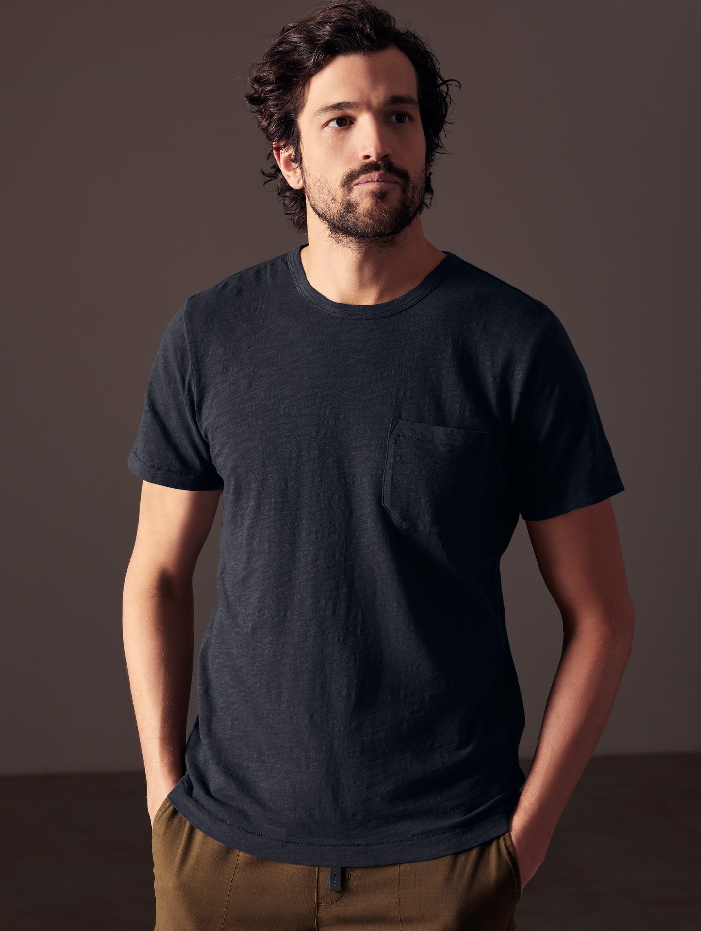 Front body view of man wearing Slub Pocket Tee in Total Eclipse dark blue from AETHER Apparel.