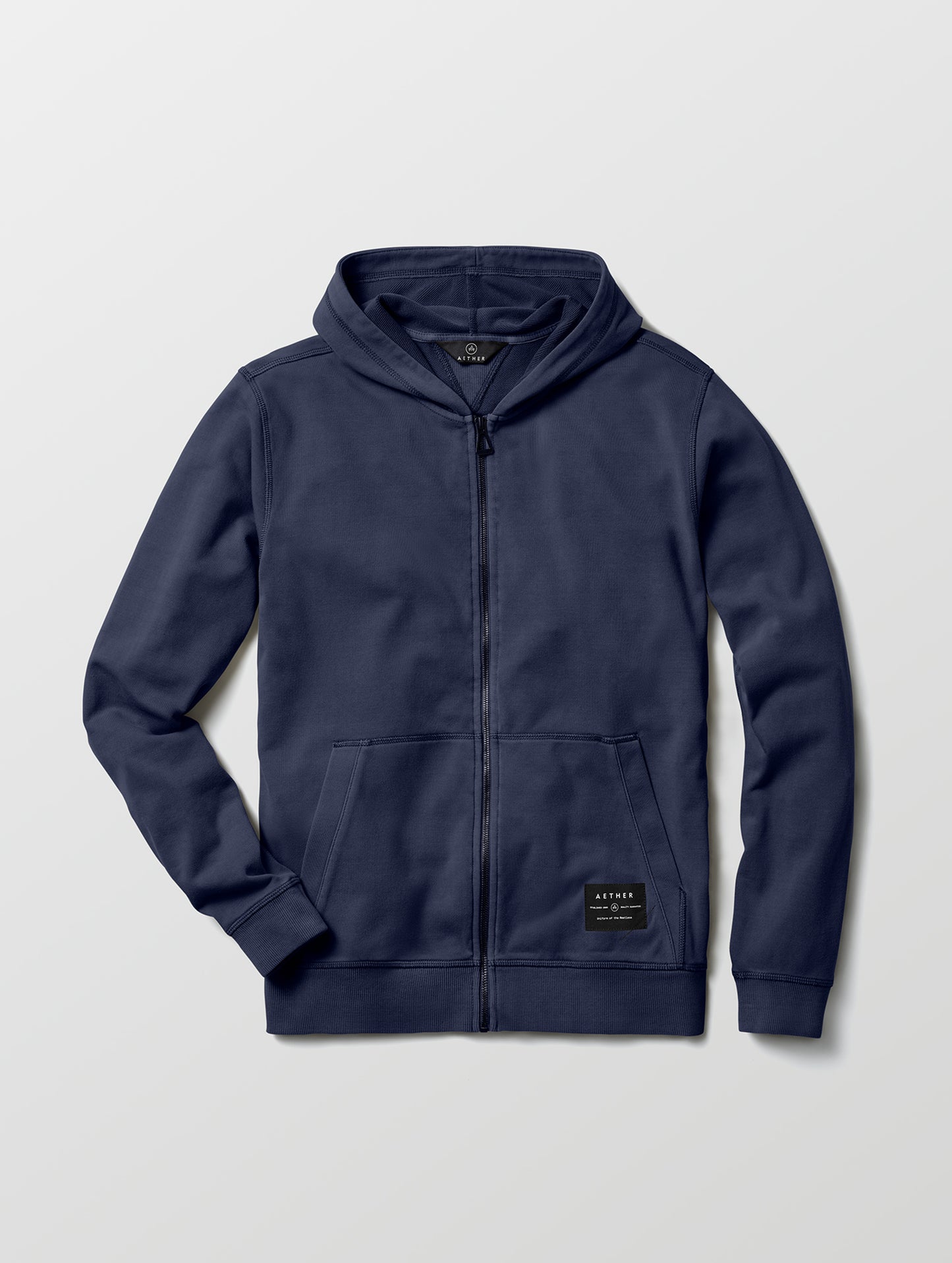 Flat lay of Solstice Lightweight Full-Zip Hoodie in Total Eclipse dark blue from AETHER Apparel.