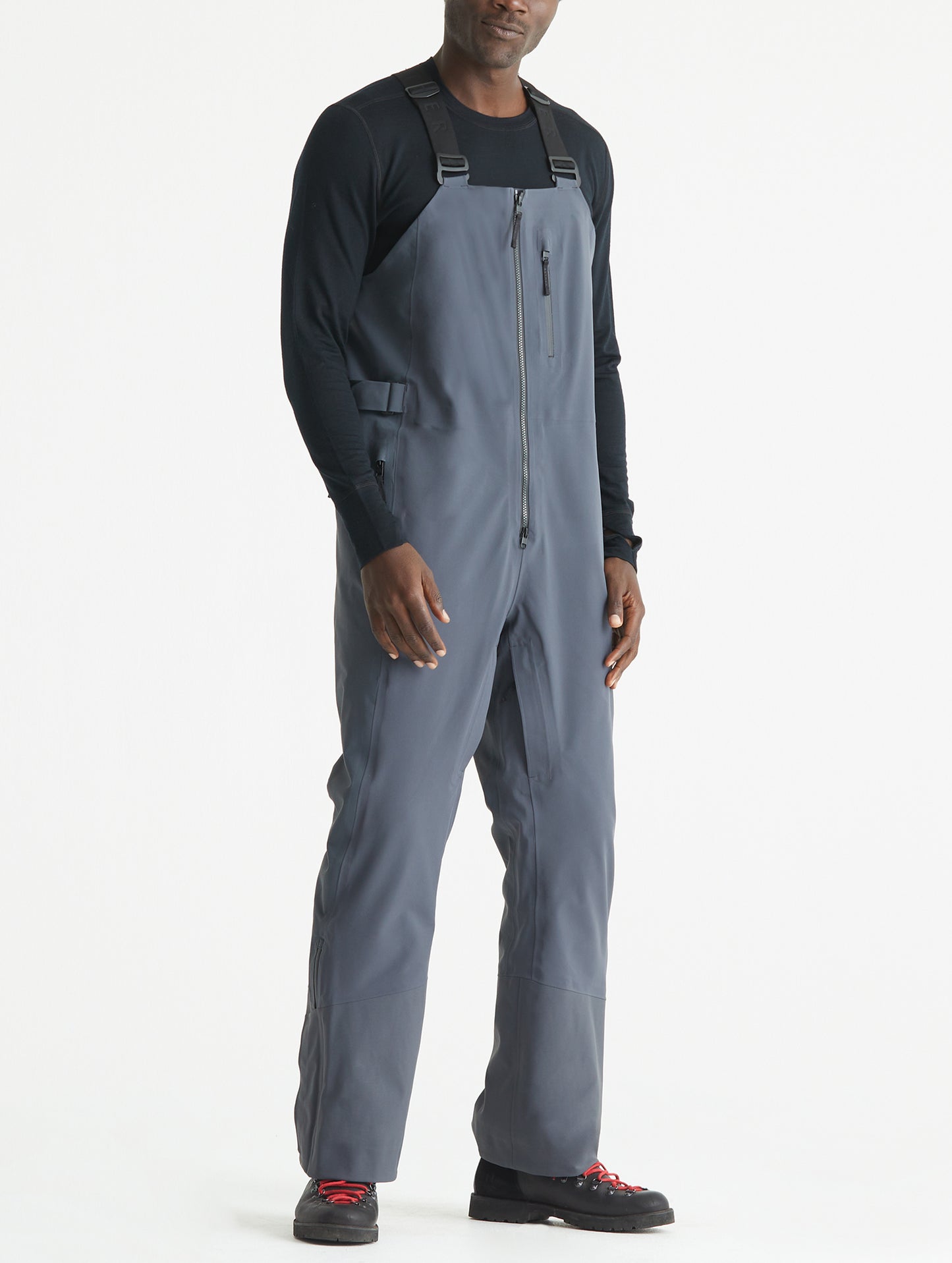 Front angled full-body view of man wearing Stealth Snow Bib in Graphite from AETHER Apparel.
