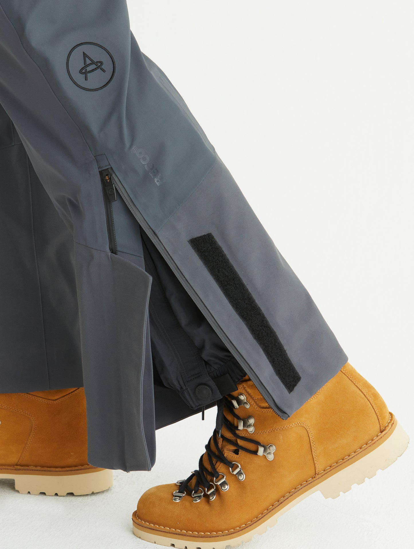 Closeup detailed view of zippered leg cuff opening on Stealth Snow Bib in Graphite from AETHER Apparel.