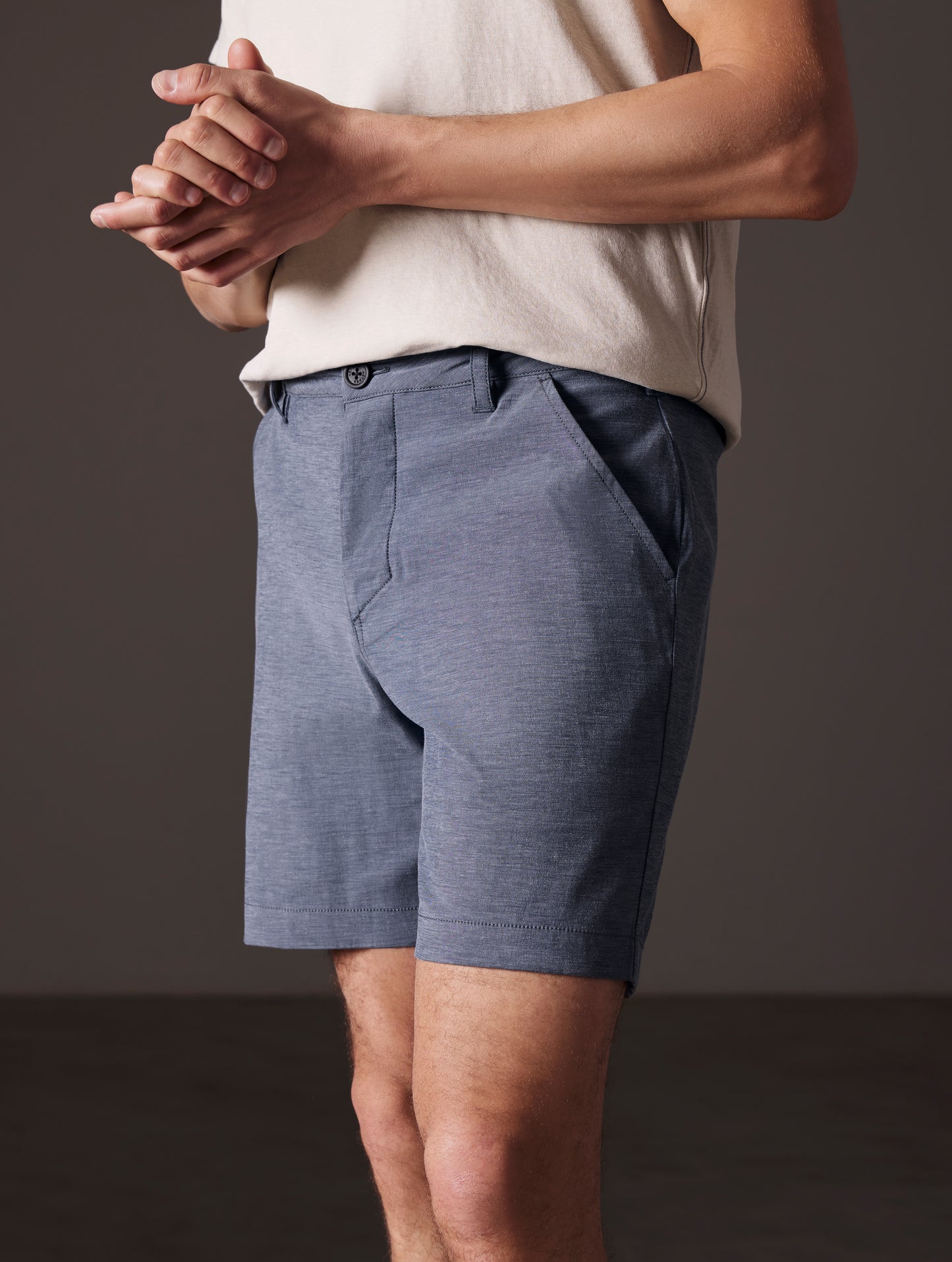 Front angled lower body view of man wearing Strand Hybrid Swim Short 7" in Slate Heather from AETHER Apparel.