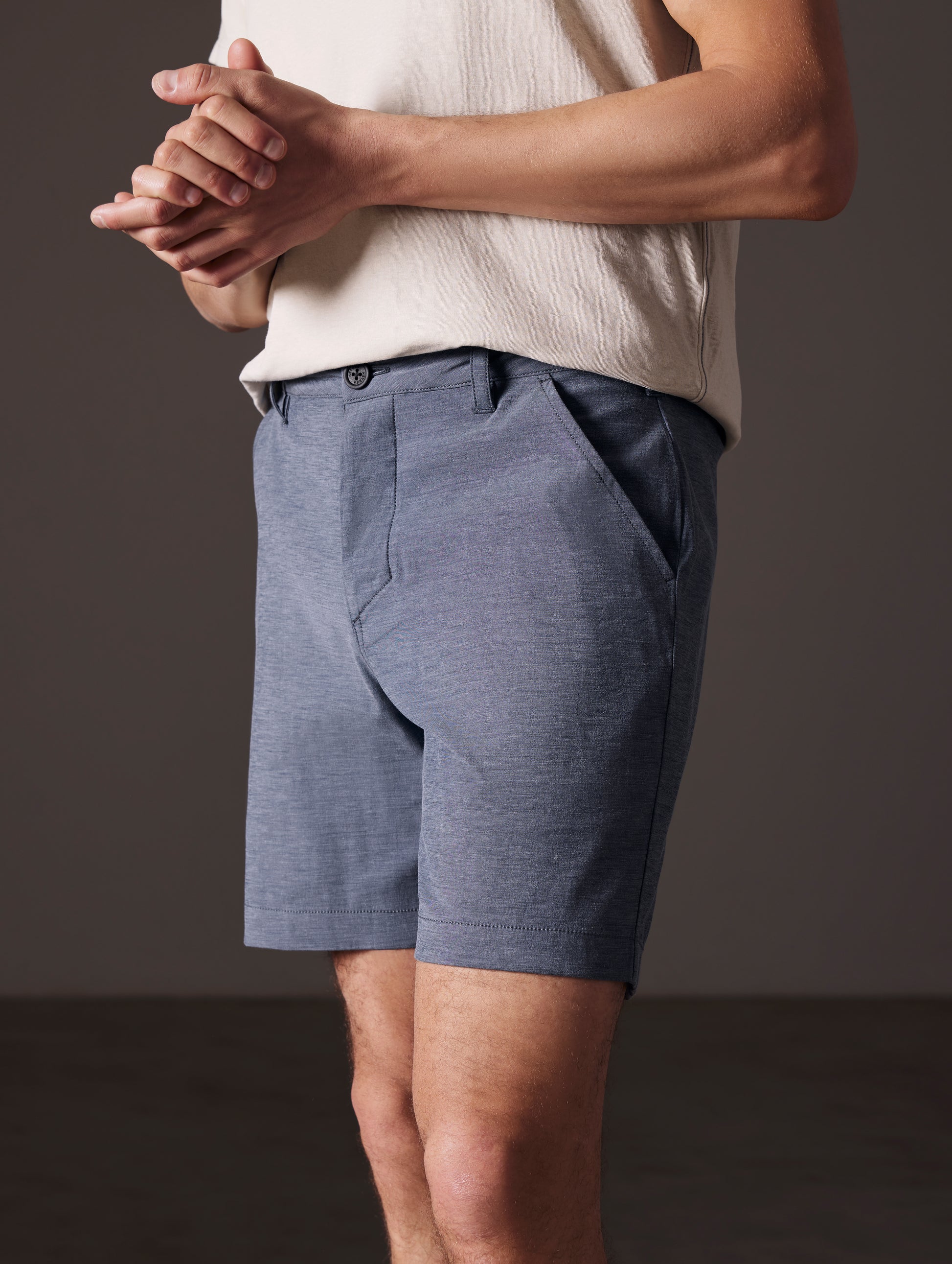 Front angled lower body view of man wearing Strand Hybrid Swim Short 7" in Slate Heather from AETHER Apparel.