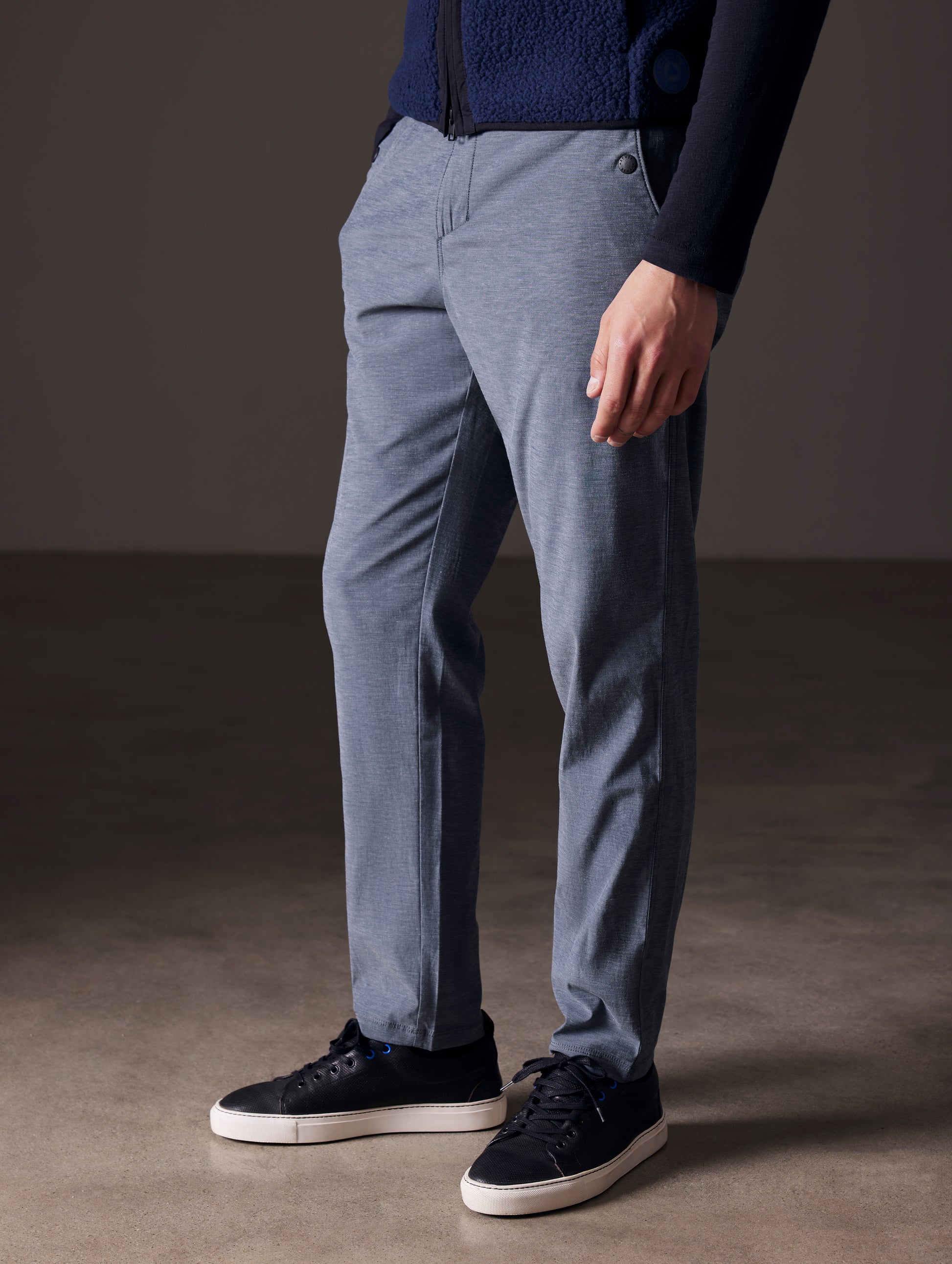 Front angled lower body view of man wearing Strand Tech Pant in Slate Heather from AETHER Apparel.
