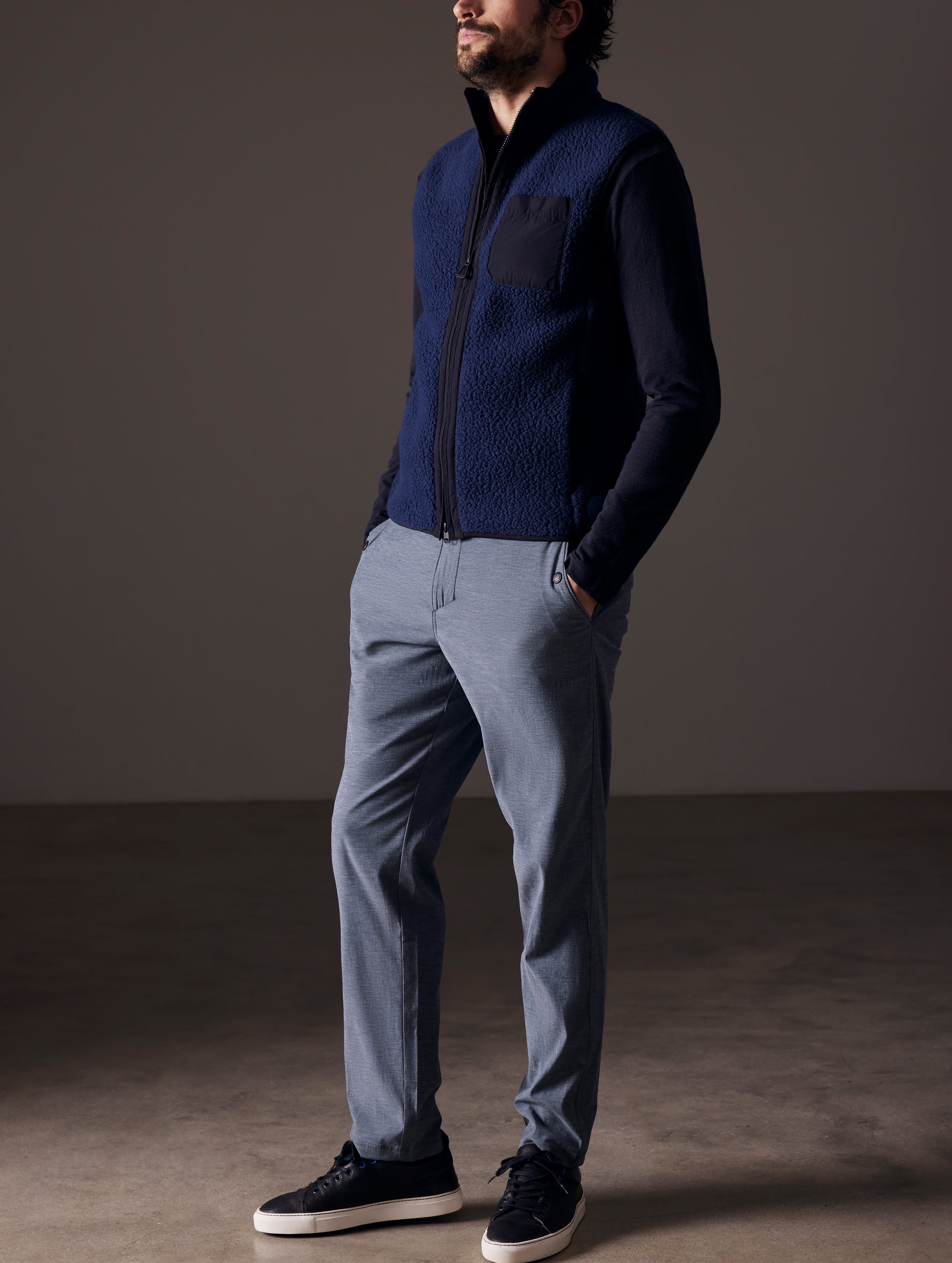 Front angled full-body view of man wearing Strand Tech Pant in Slate Heather from AETHER Apparel.