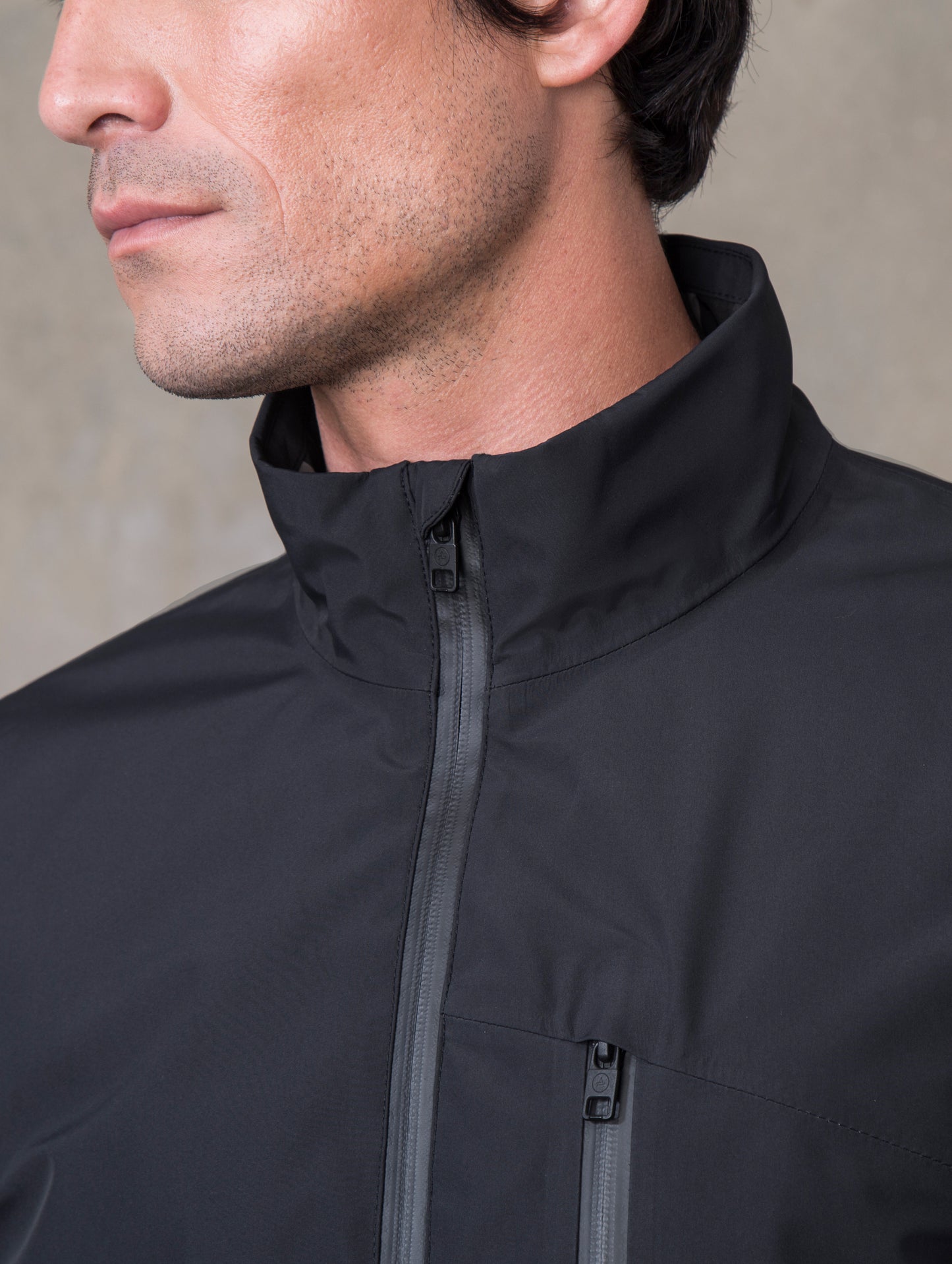 Man wearing black Tundra Jacket from ATHER Apparel, with collar in close view.