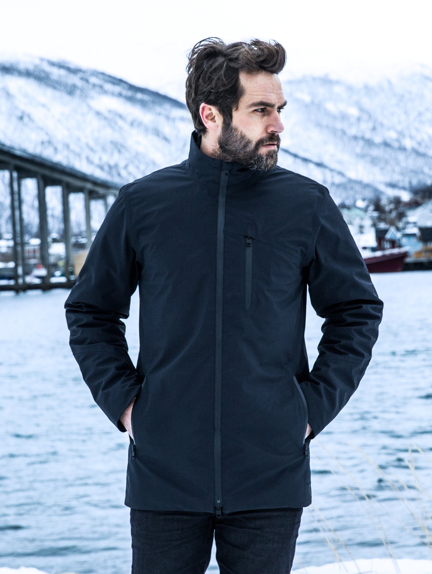 Man outdoors wearing black Tundra Jacket from ATHER Apparel.