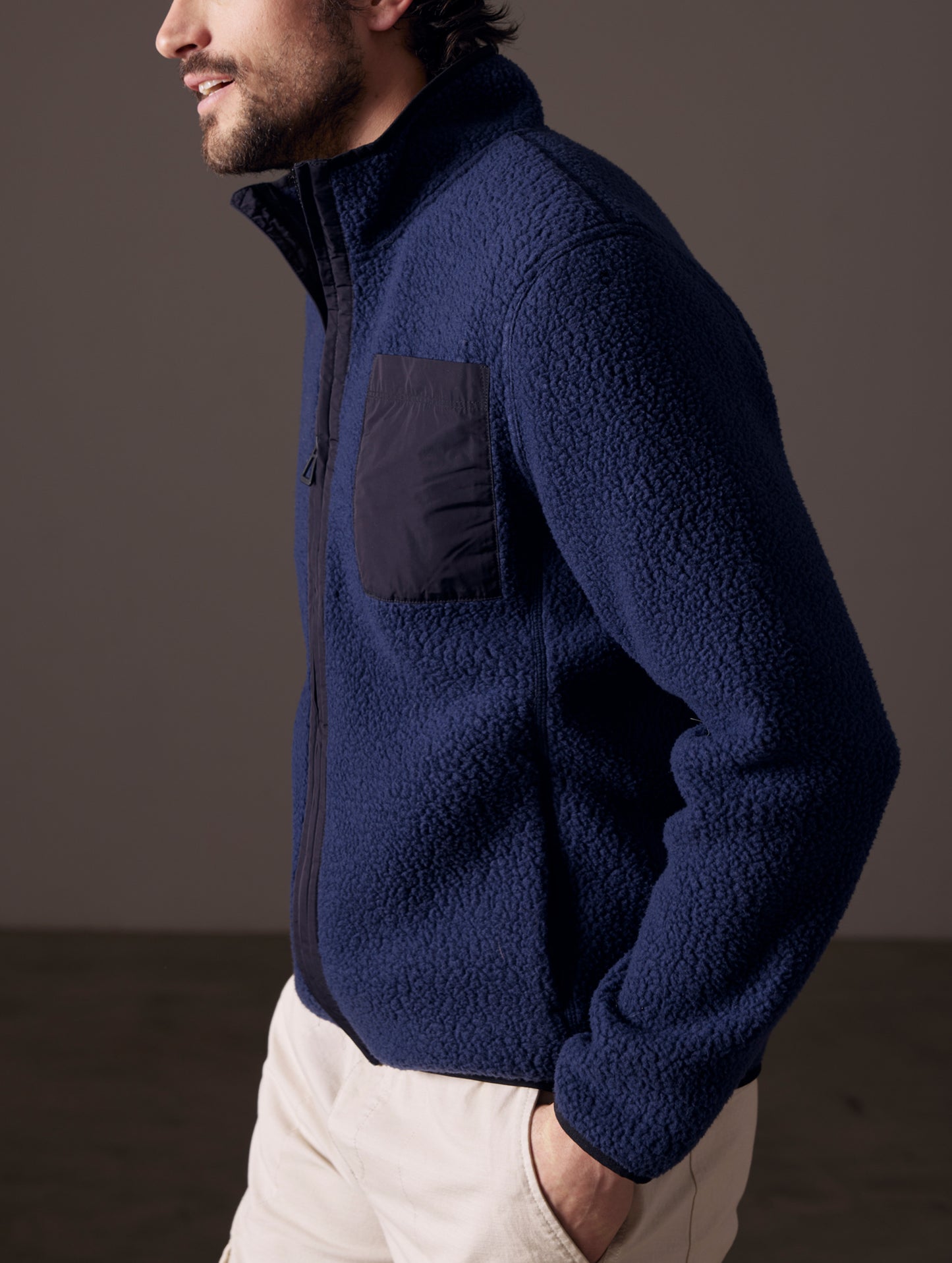 Side profile body view of man wearing Walsh Full-Zip in Nordic Navy from AETHER Apparel.