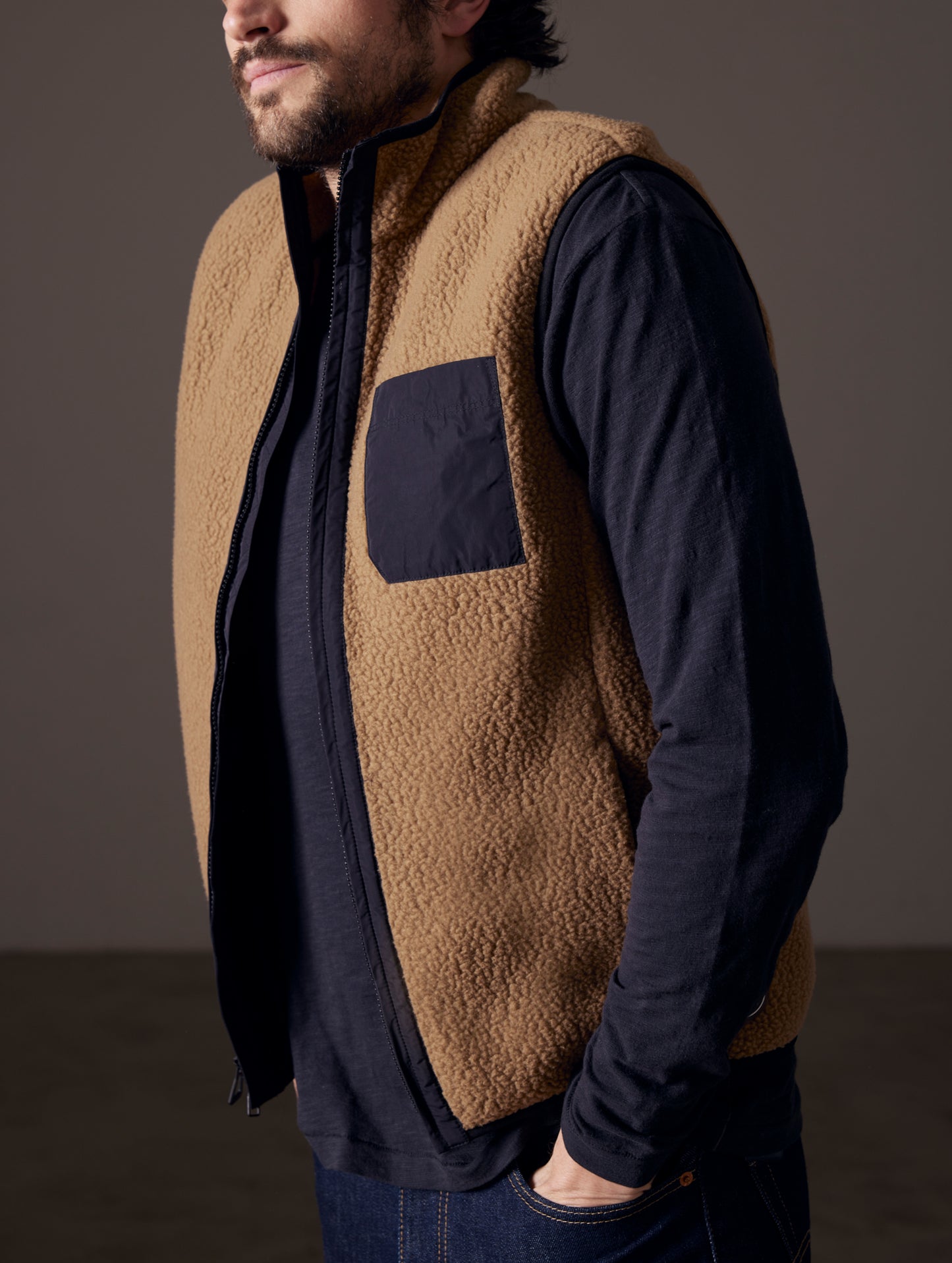 Front 3/4 body view of man wearing Walsh Vest in Reserve Brown from AETHER Apparel.
