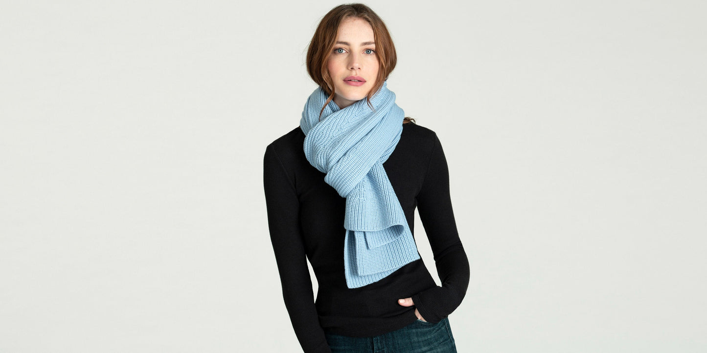 Woman wearing light blue Peak Scarf from AETHER Apparel.