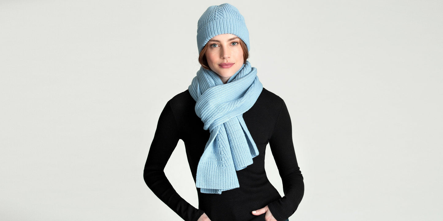 Woman wearing light blue Peak Scarf from AETHER Apparel and matching beanie.
