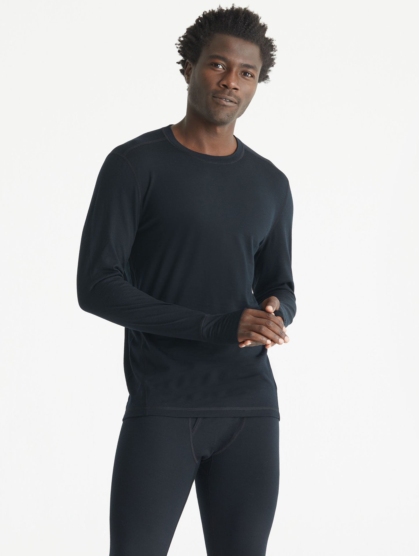 Front body view of man wearing Premium Merino Base Layer Crew in Jet Black from AETHER Apparel.