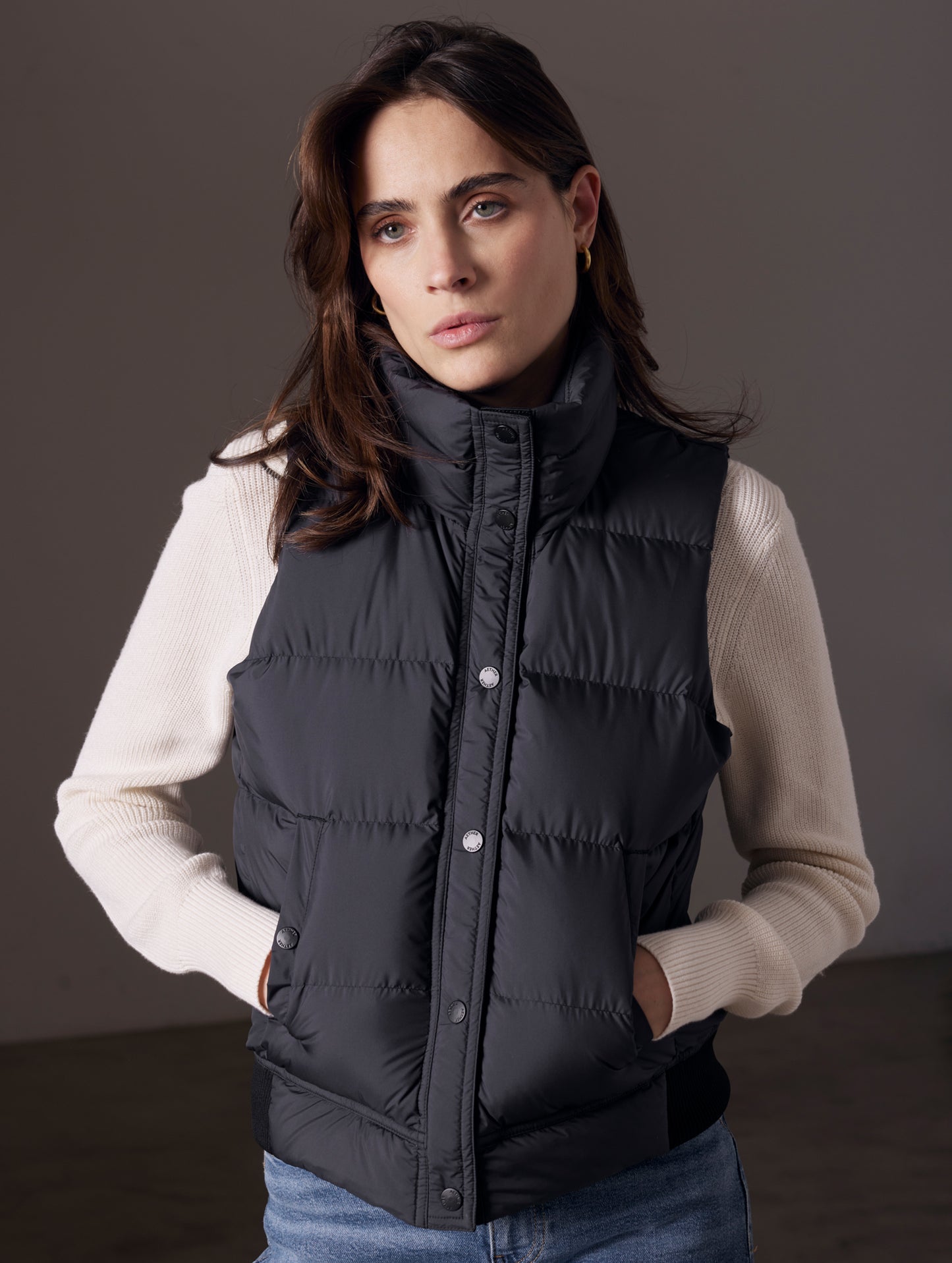 Woman wearing black buttoned Anning insulated vest from AETHER Apparel.