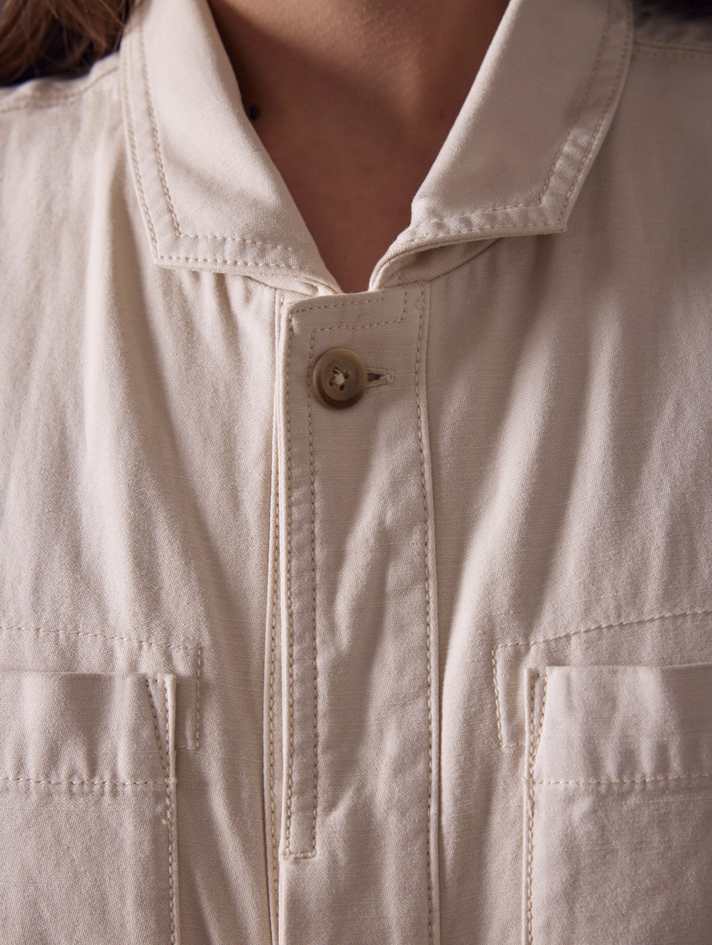 woman wearing beige short-sleeve jumpsuit from AETHER Apparel