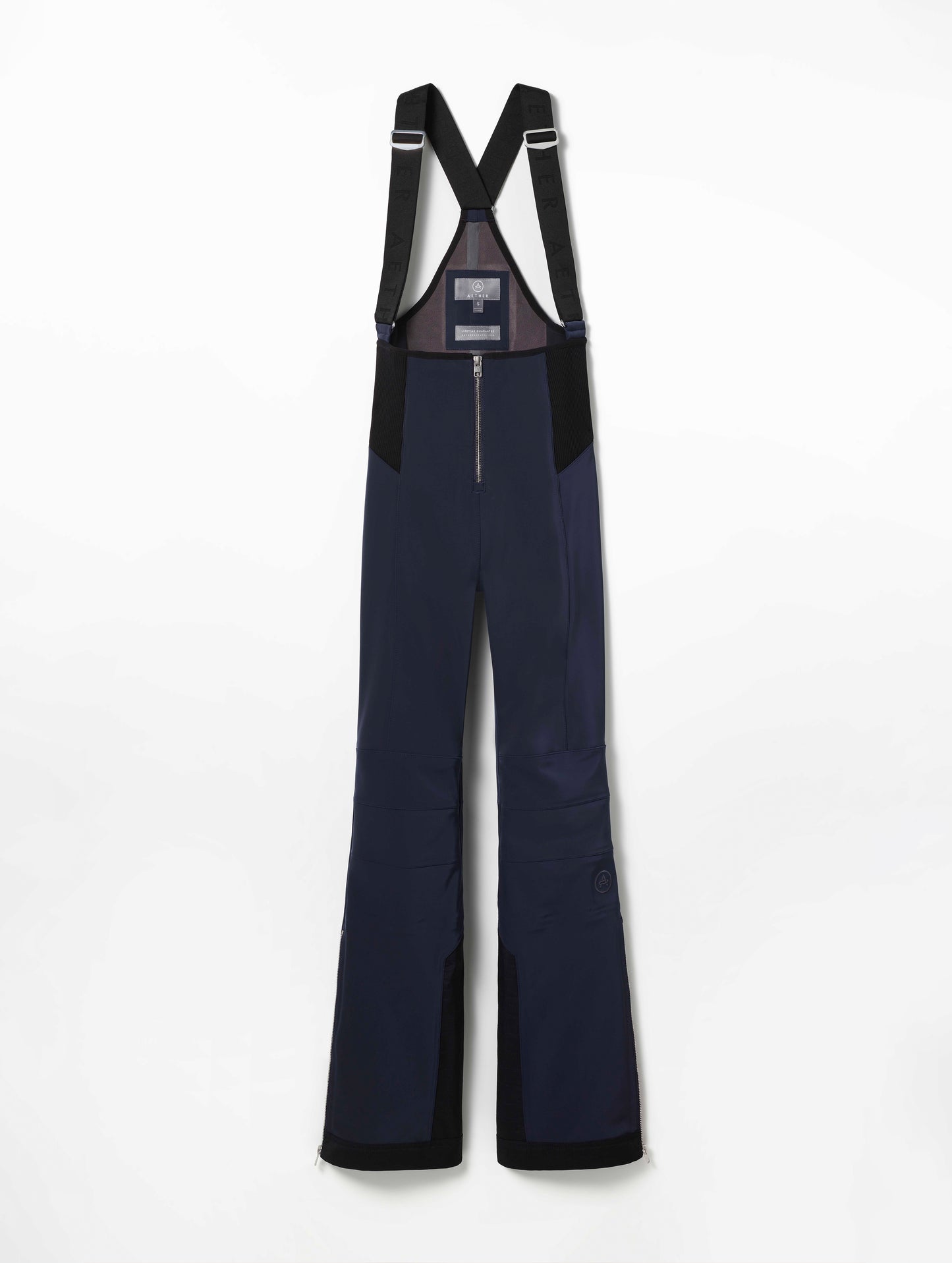 Flat lay of women's Descent Snow Bib 2.0 in Total Eclipse dark blue from AETHER Apparel.