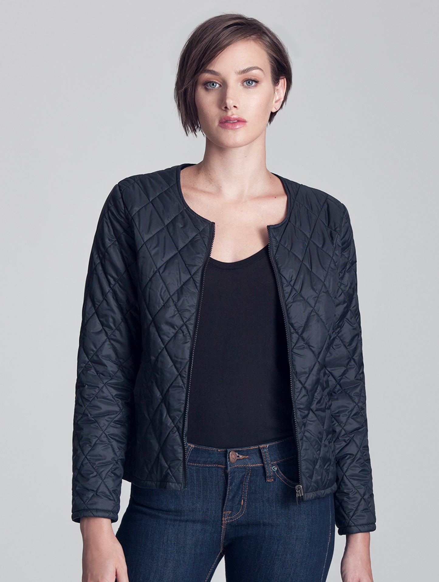 Woman wearing unzipped black liner of Crosby Jacket from AETHER Apparel.