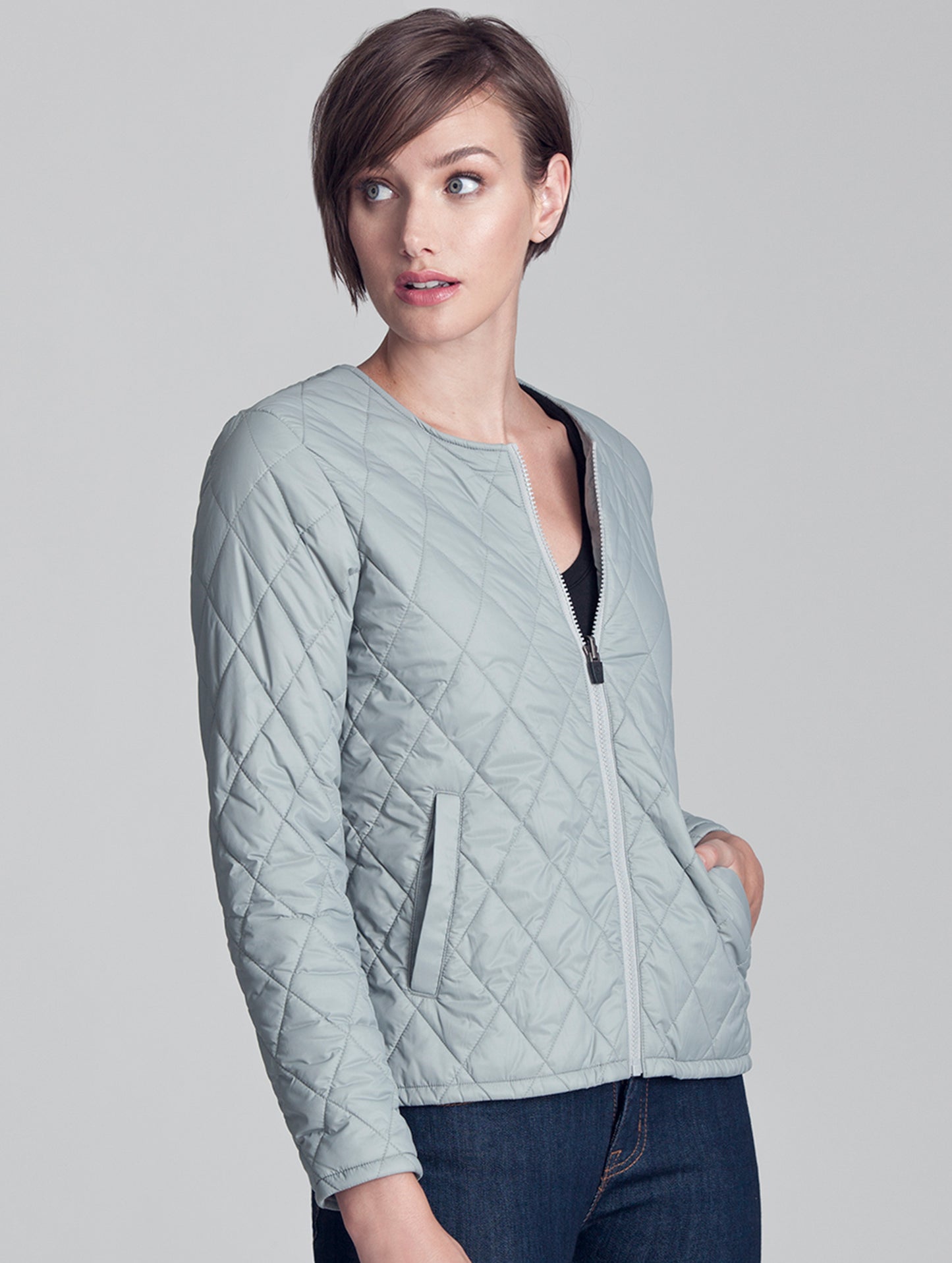 Woman wearing light grey liner of Crosby Jacket from AETHER Apparel.