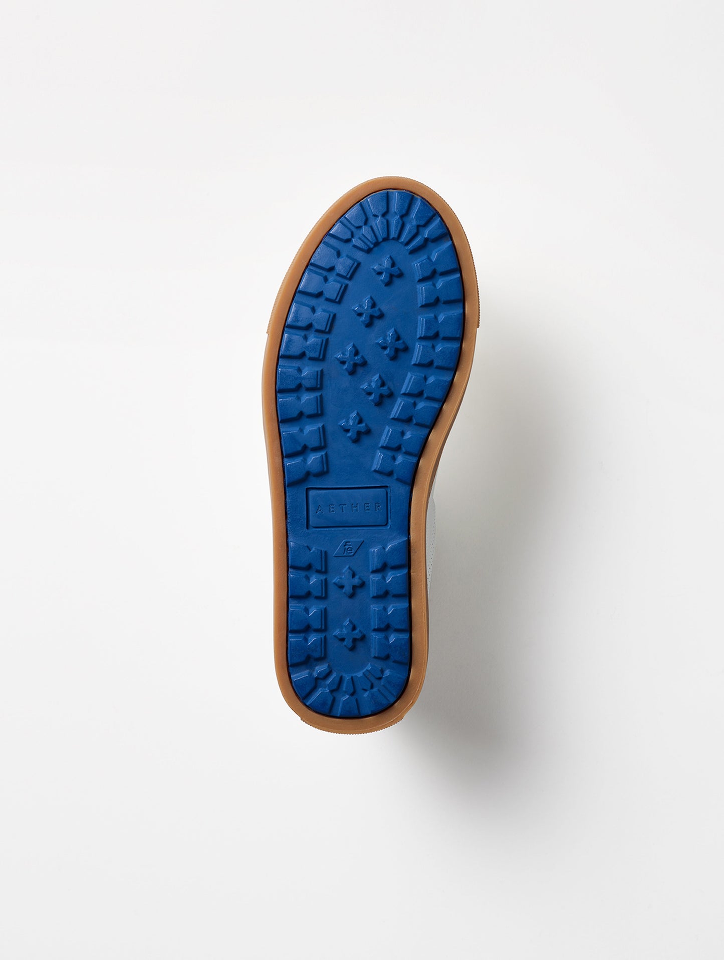 View of blue rubber outsole on bottom of women's Dalton Low-Top Sneaker in White from AETHER Apparel.